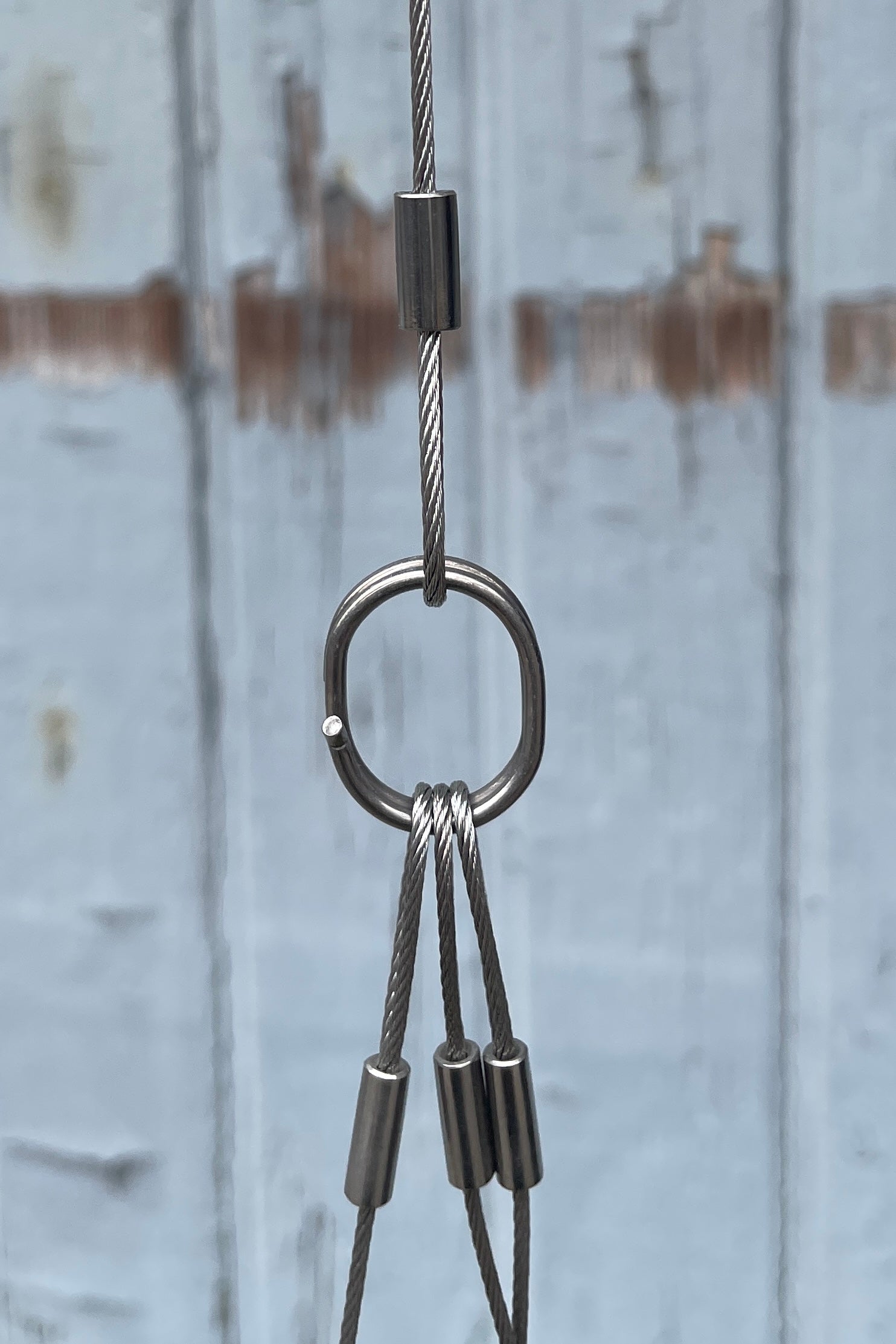 The silver metal hardware of the spherical hanging planter at Sprout Home.