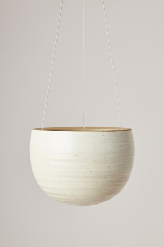 Spherical Hanging Planter
Creamy White Speckle
by Angus & Celeste hanging and empty against a white wall.