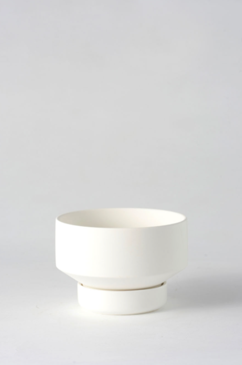 The small white Collector's Gro Pot by Angus & Celeste shown empty and against a white wall.