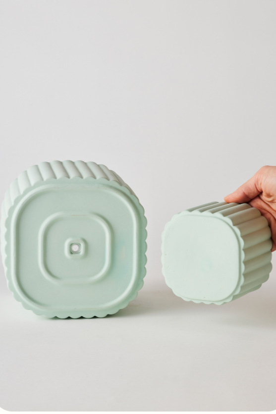 A Mint Modular Stack Planter by Angus & Celeste showing the undersides of both the main pot and reservoir pot separate from one another