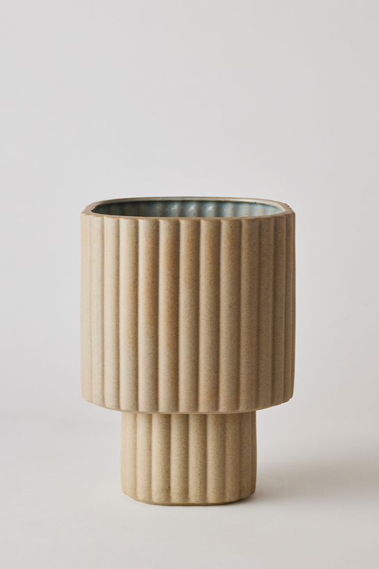 Sand colored Modular Stack planter by Angus & Celeste being shown empty in front of a white wall.
