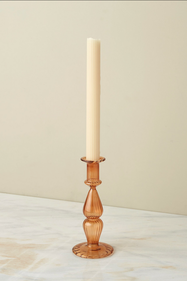 The marmalade Nahlia candlestick holder with an ivory taper candle.