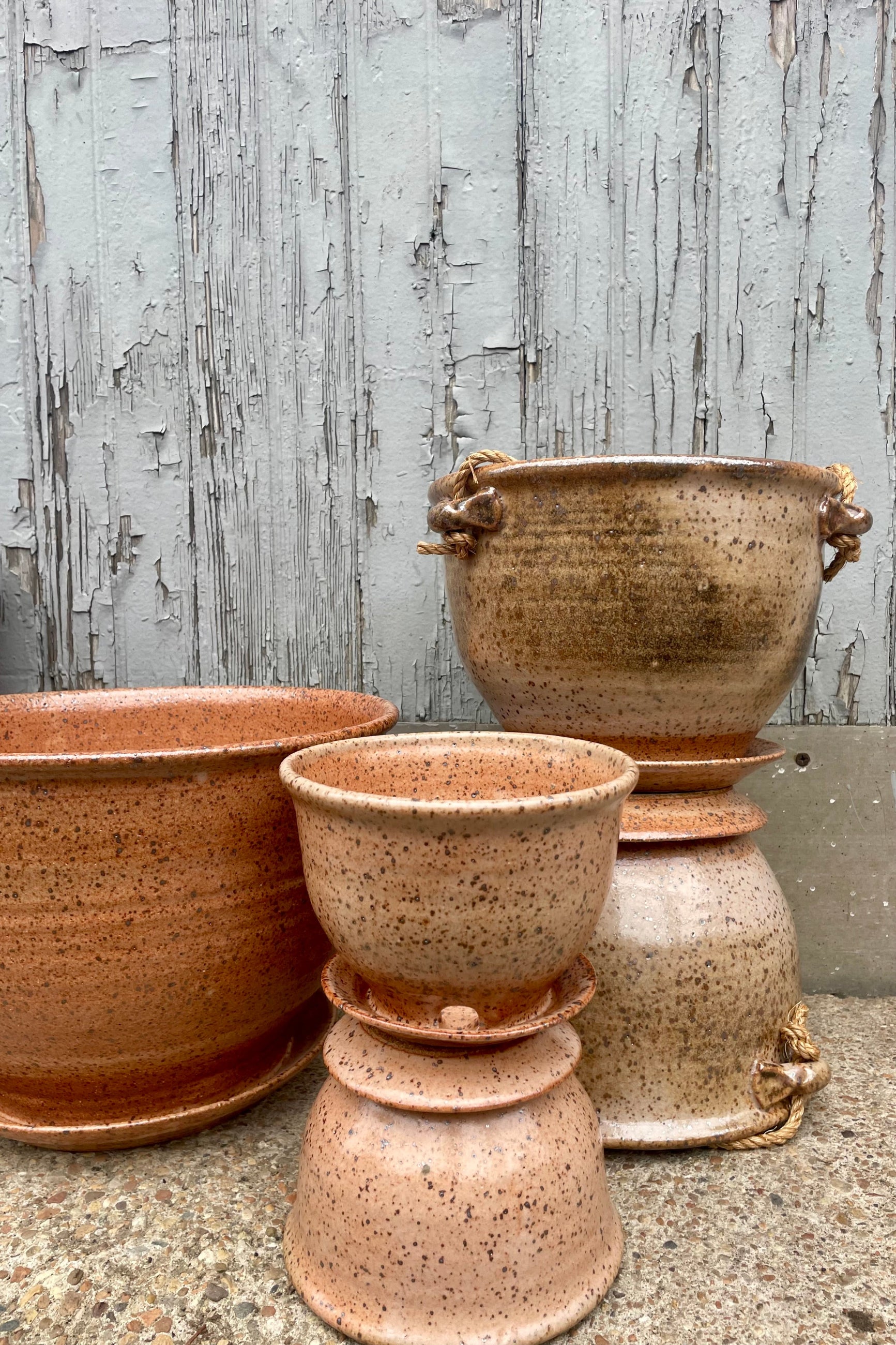 A groupd of glazed pottery in front of a wooden wall ©Sprout Home