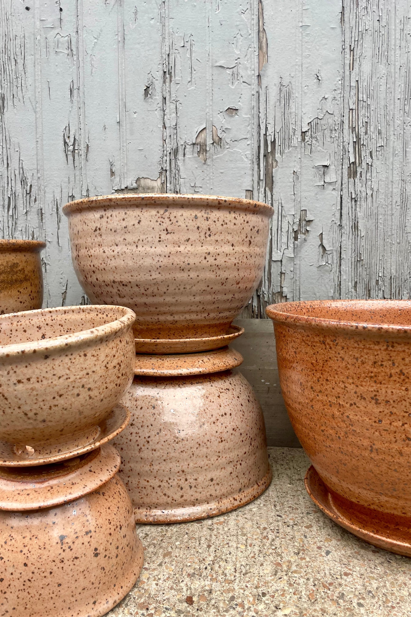 A groupd of glazed pottery in front of a wooden wall ©Sprout Home