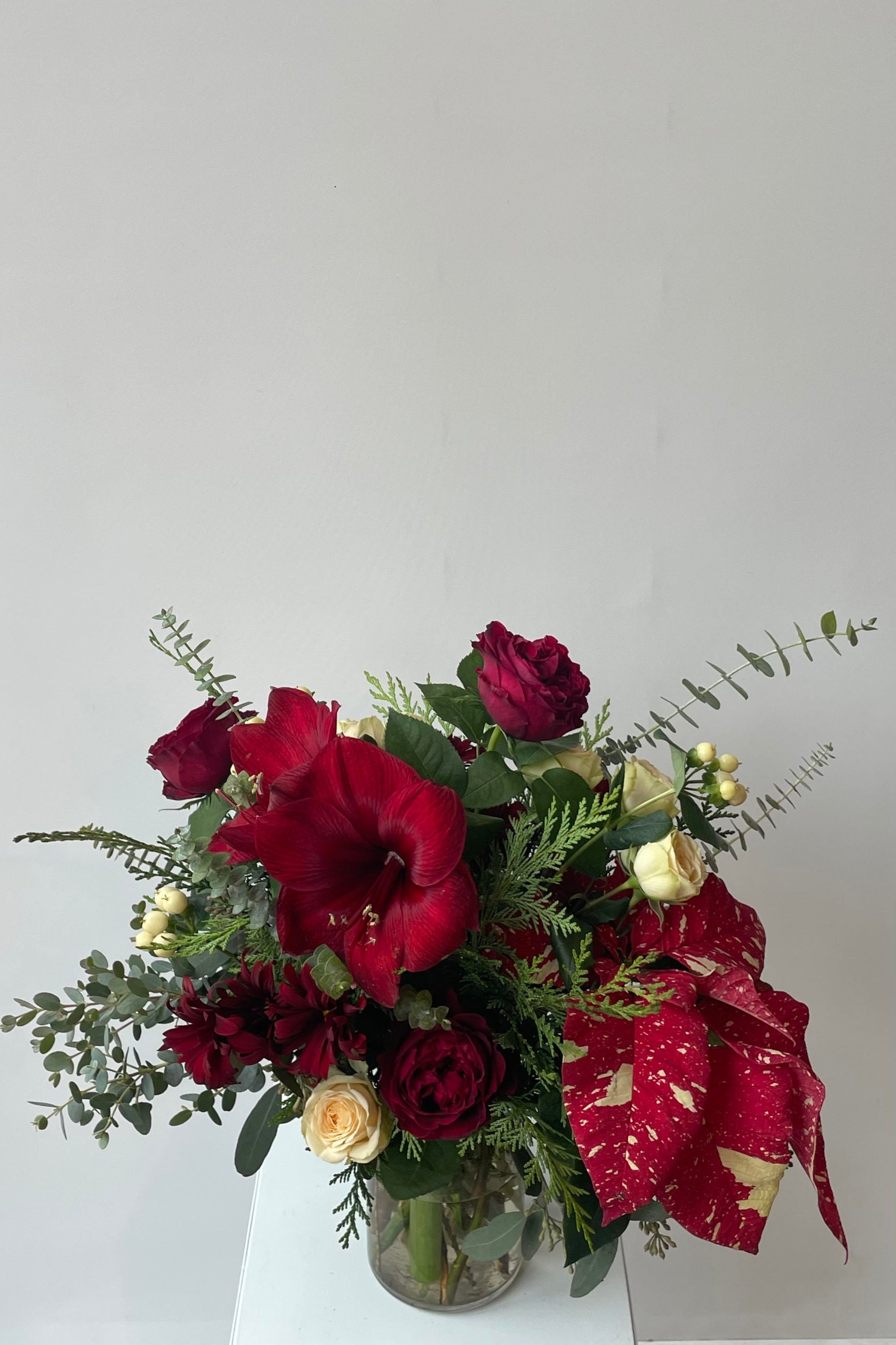 A custom floral arrangement featuring red Amaryllis ©Sprout Home #size_$100