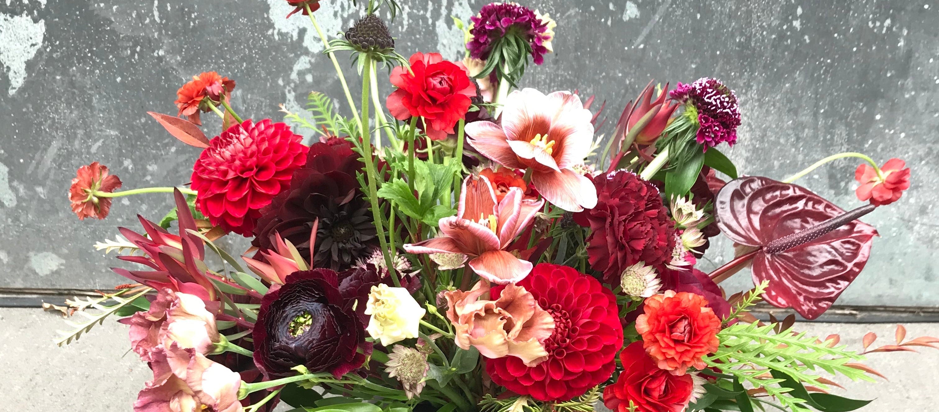 Red palette winter arrangement by Sprout Home featuring reflexed tulips ©Sprout Home