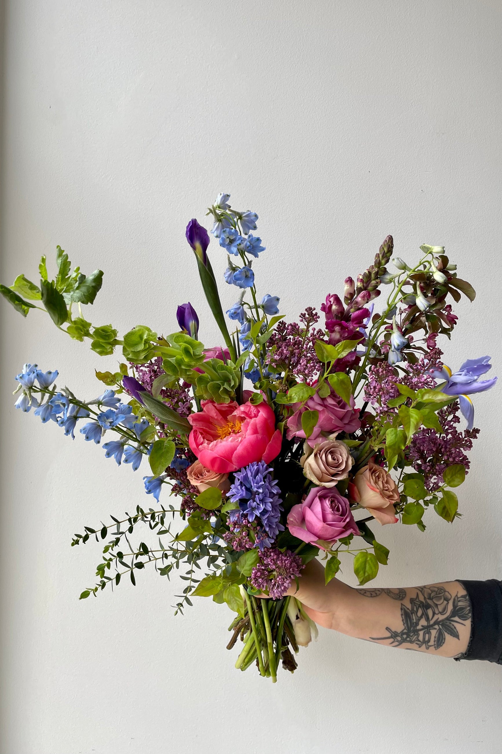 Handheld custom arrangement featuring a storm palette with a fuchsia peony focal point mid May ©Sprout Home #size_$200
