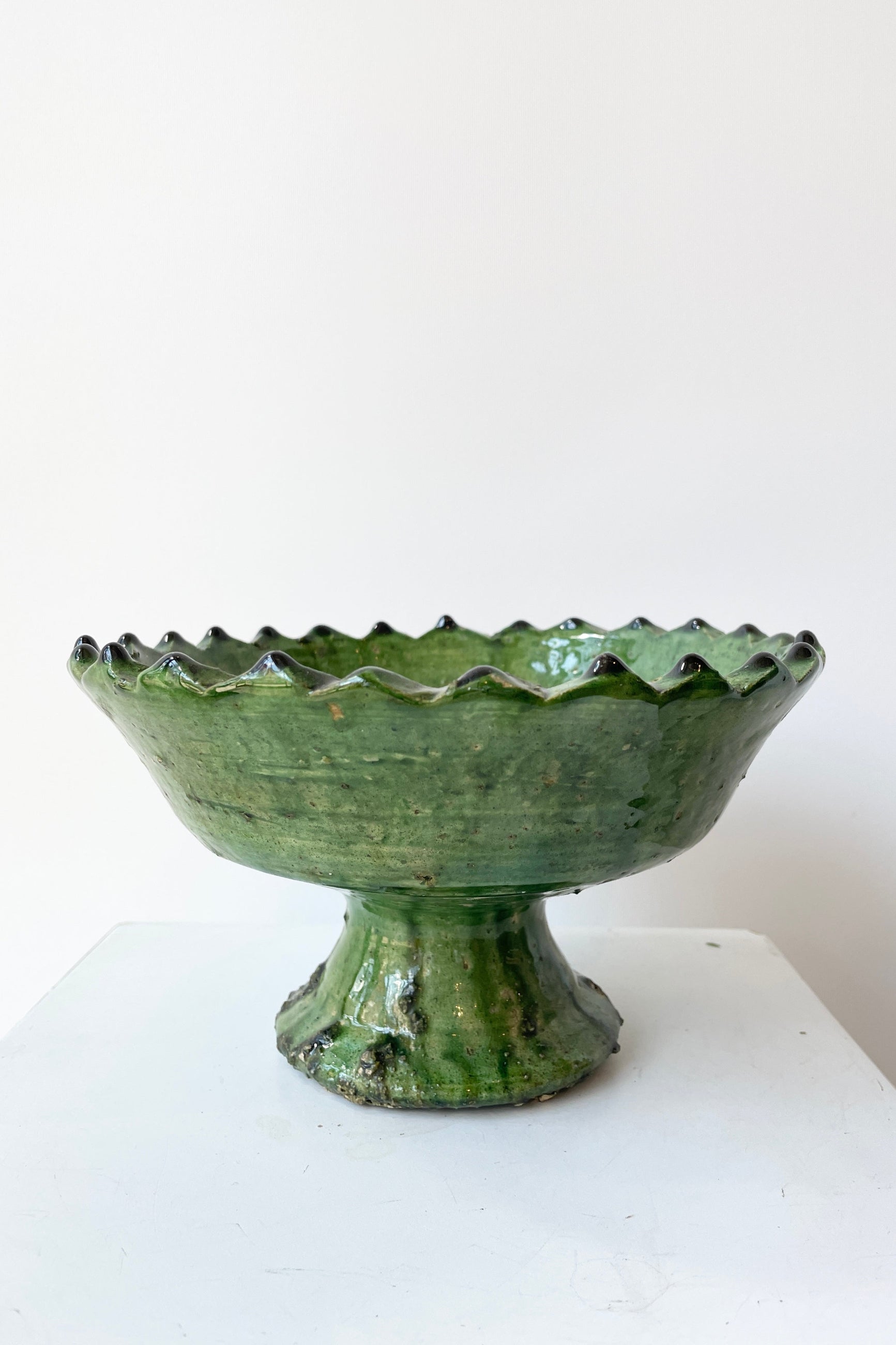 The Tamegroute Green compote at Sprout Home viewed from the side at eye level against a white wall. ©Sprout Home