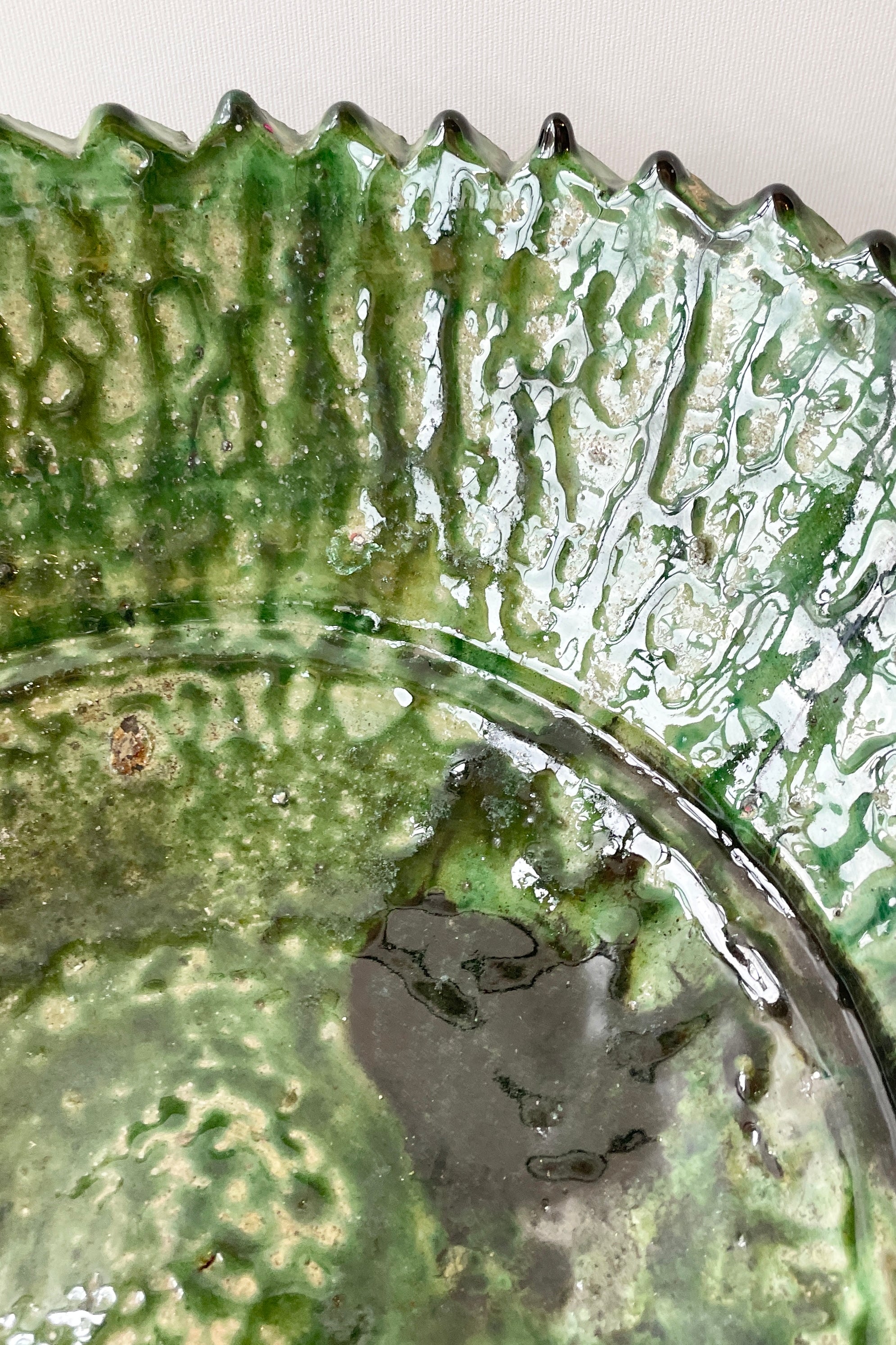 A detail image of the green mottled glaze of the the Tamegroute vessels at Sprout Home.