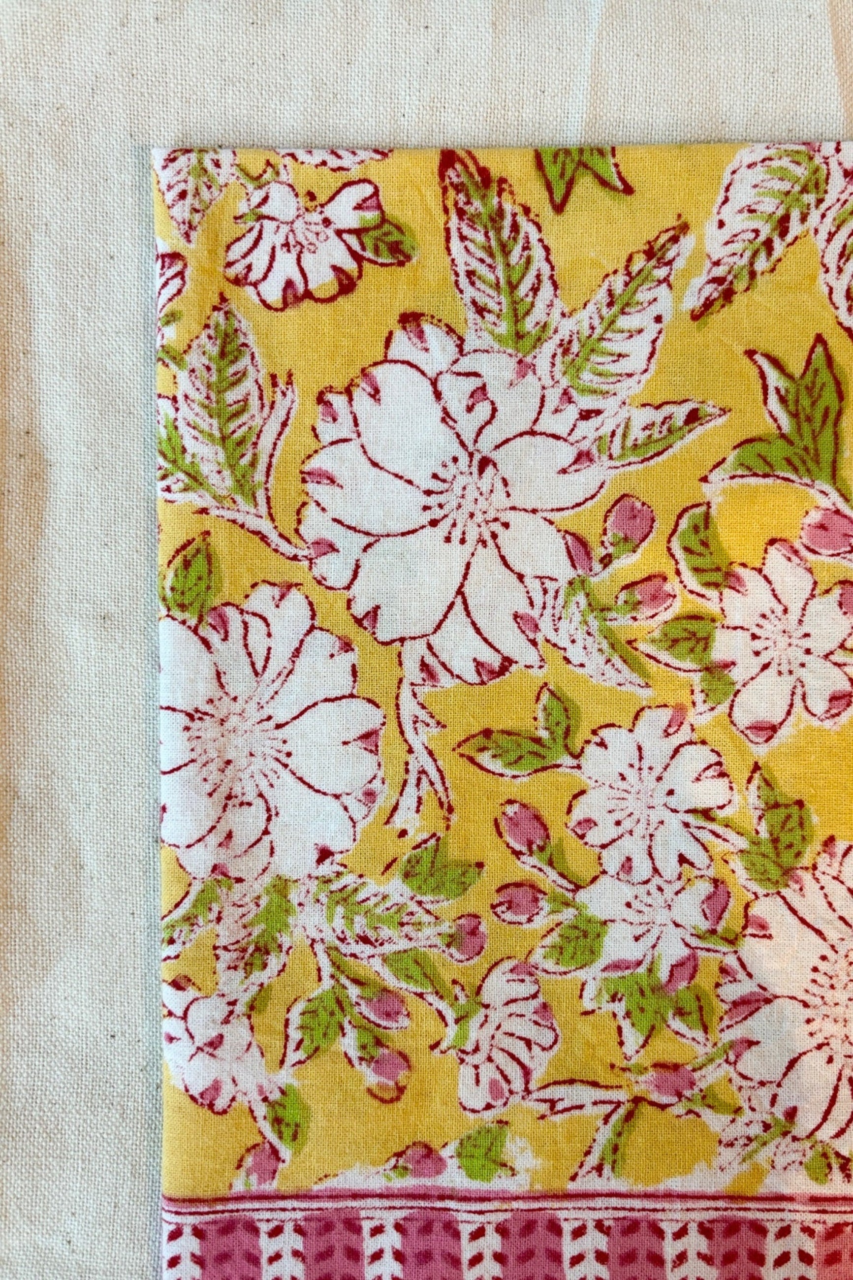 Hand printed, 100% cotton Camelia yellow and pink floral print tablecloth with natural napkin ©Sprout Home
