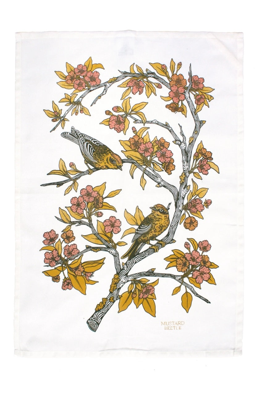 A pink and yellow screenprint of birds on branches on a white cotton tea towel ©Mustard Beetle