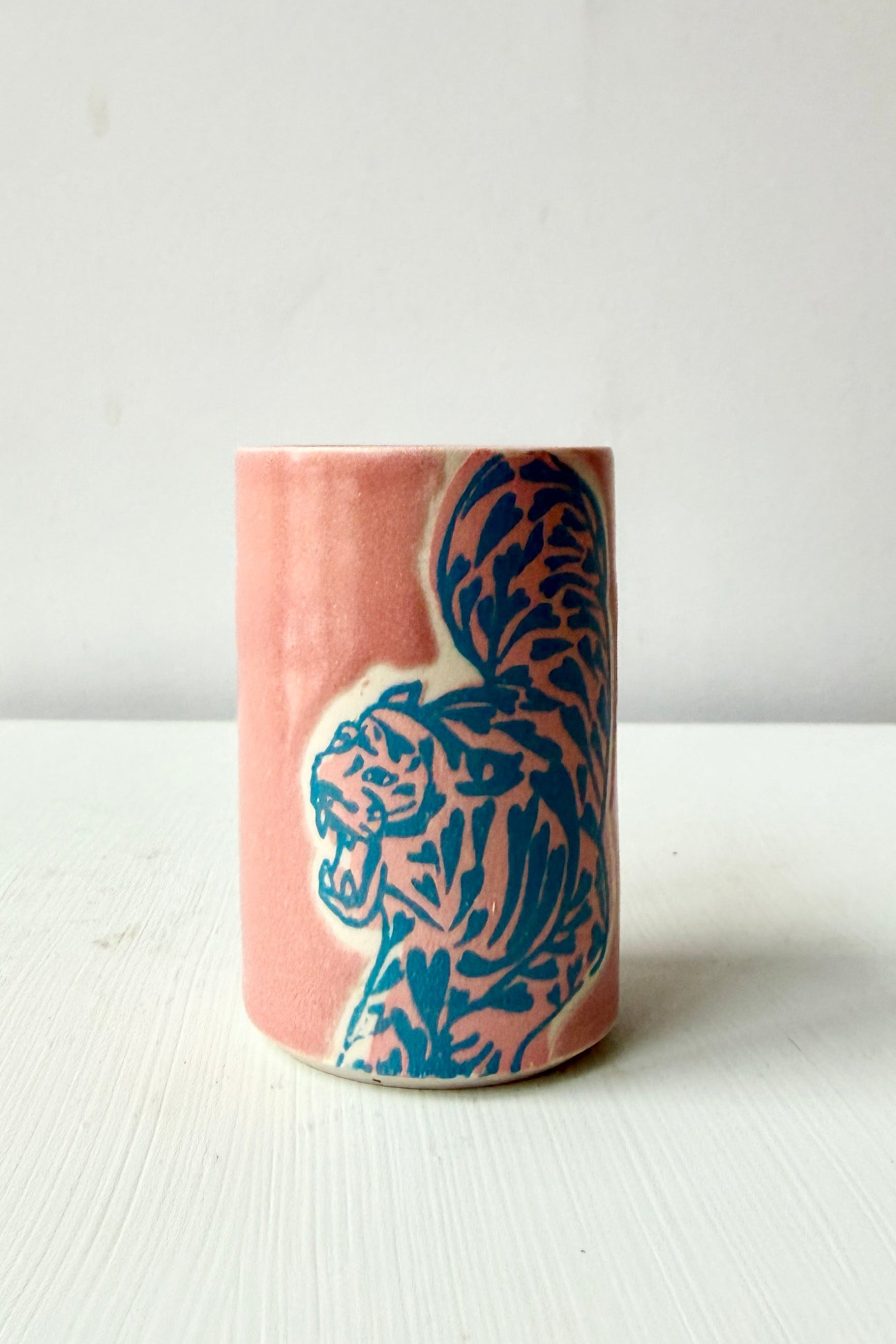 Ceramic vase with blue tiger design on a pink background ©Sprout Home