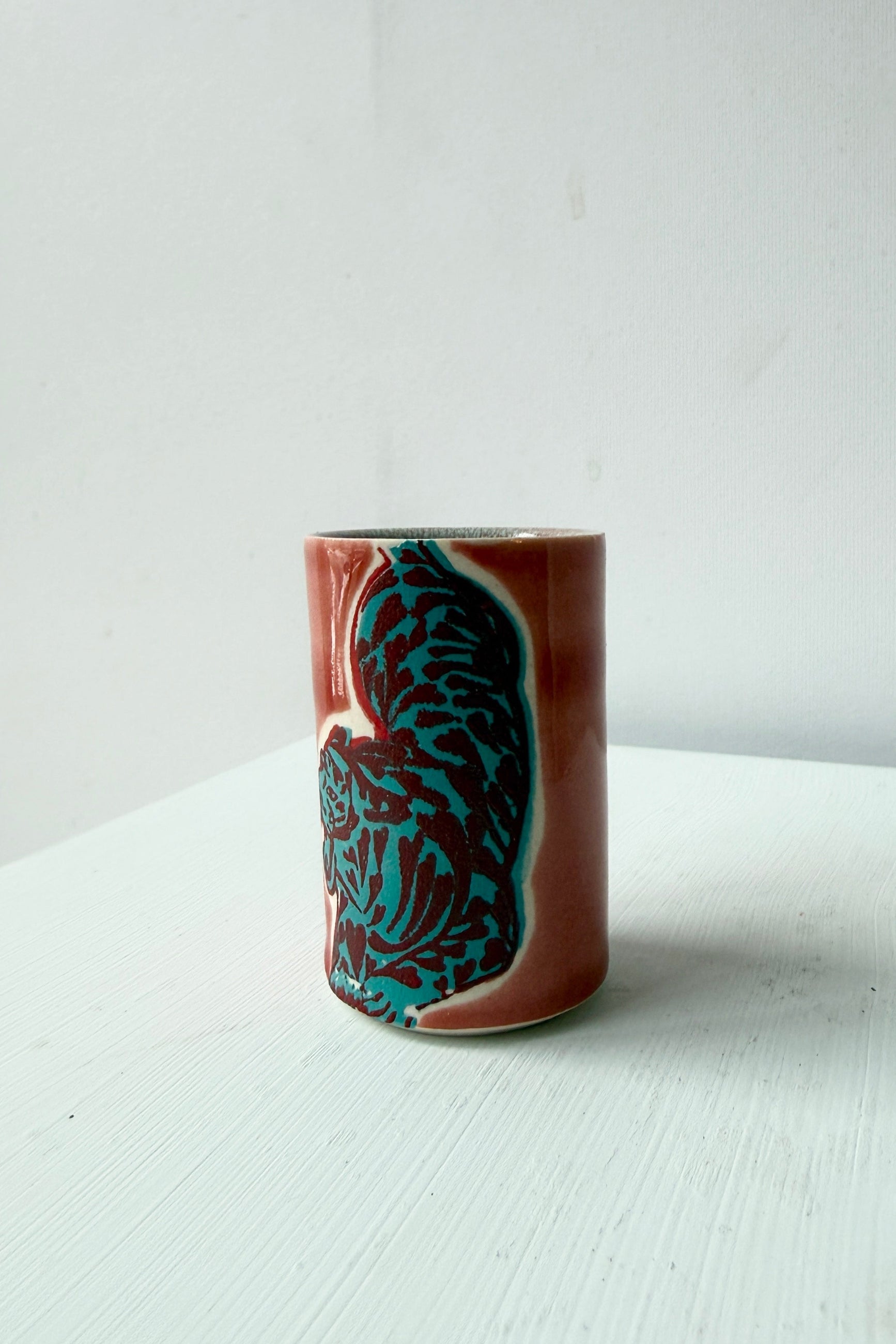 Ceramic tiger mug in teal and red design by City in Bloom Ceramics on a white surface ©Sprout Home