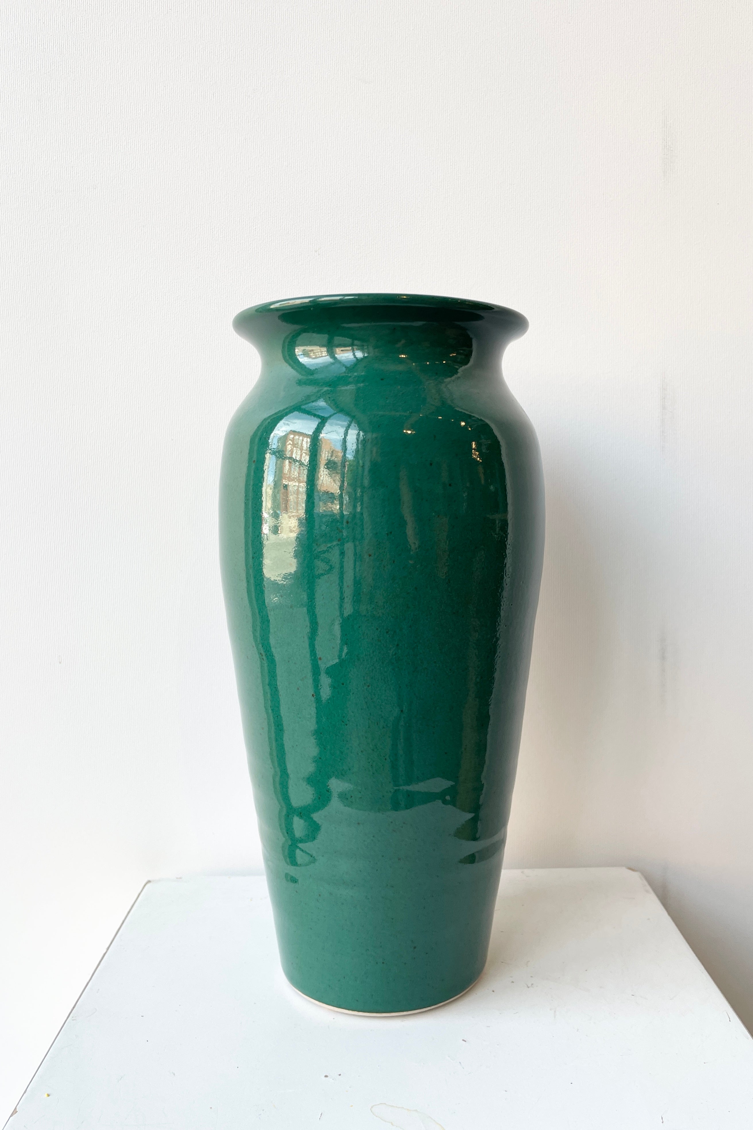 Tall vase jade green glaze viewed from the sides with its shine.