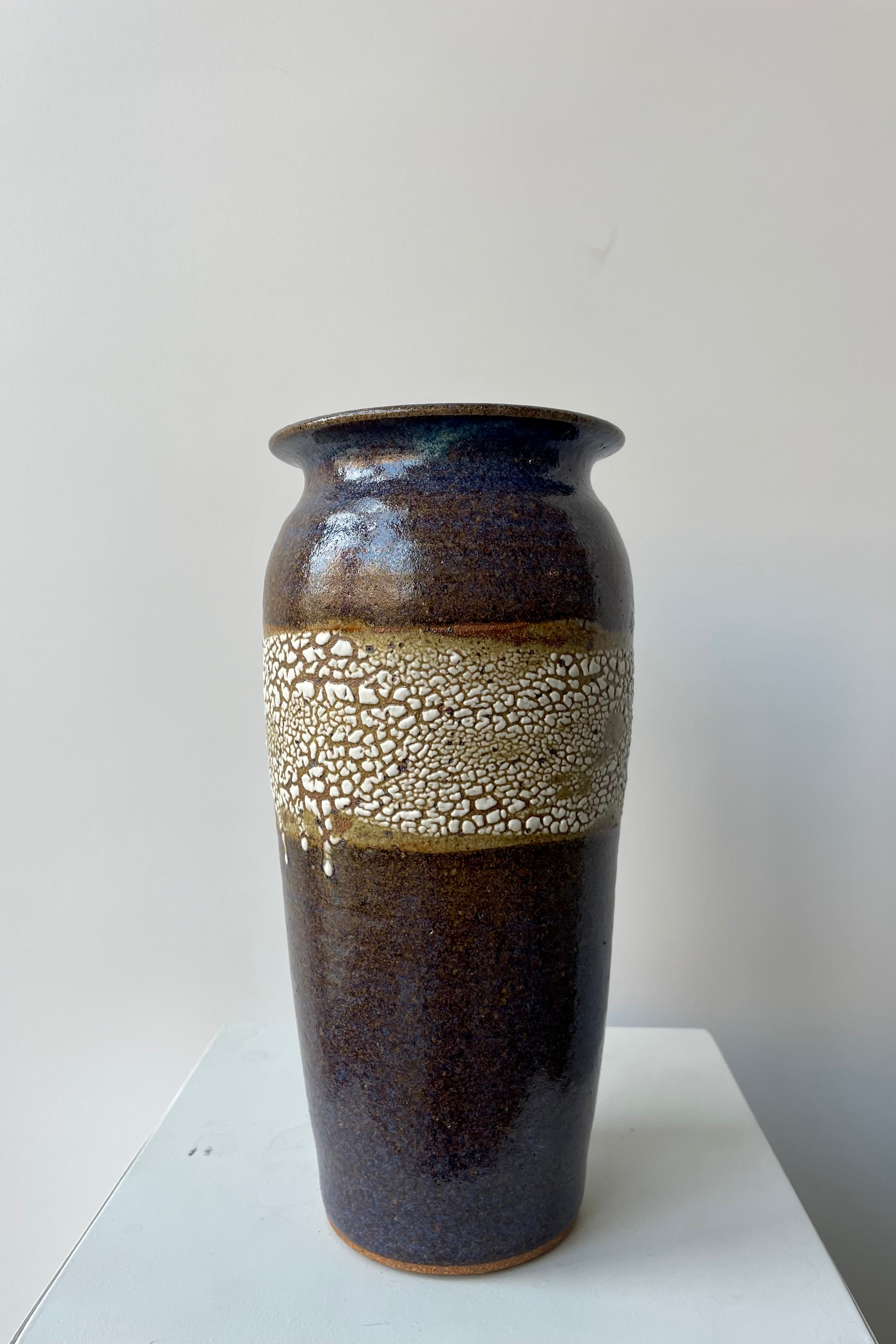Bruning Pottery "super crackle" glazed tall ceramic vase in front of white background