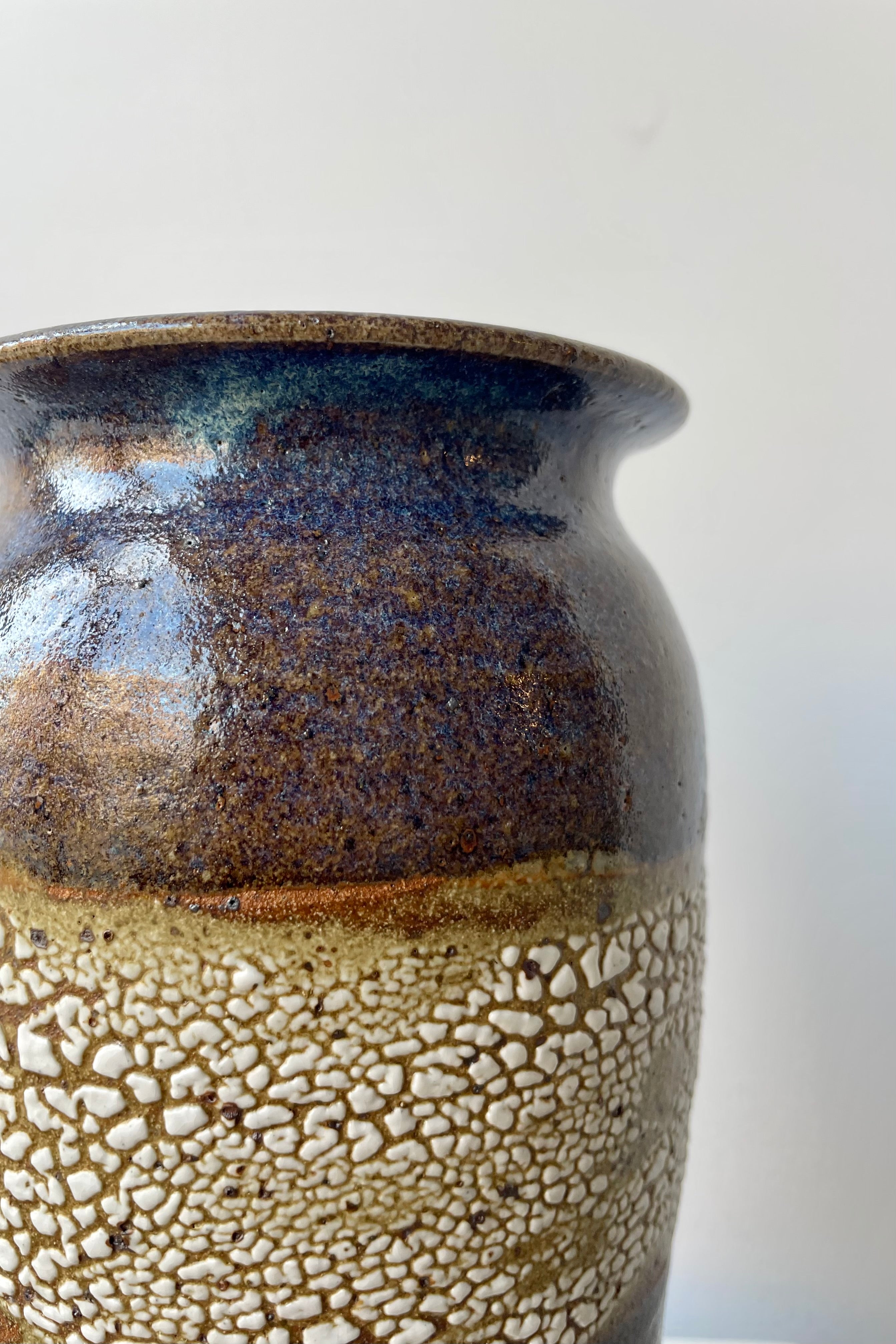 Bruning Pottery "super crackle" glazed tall ceramic vase in front of white background