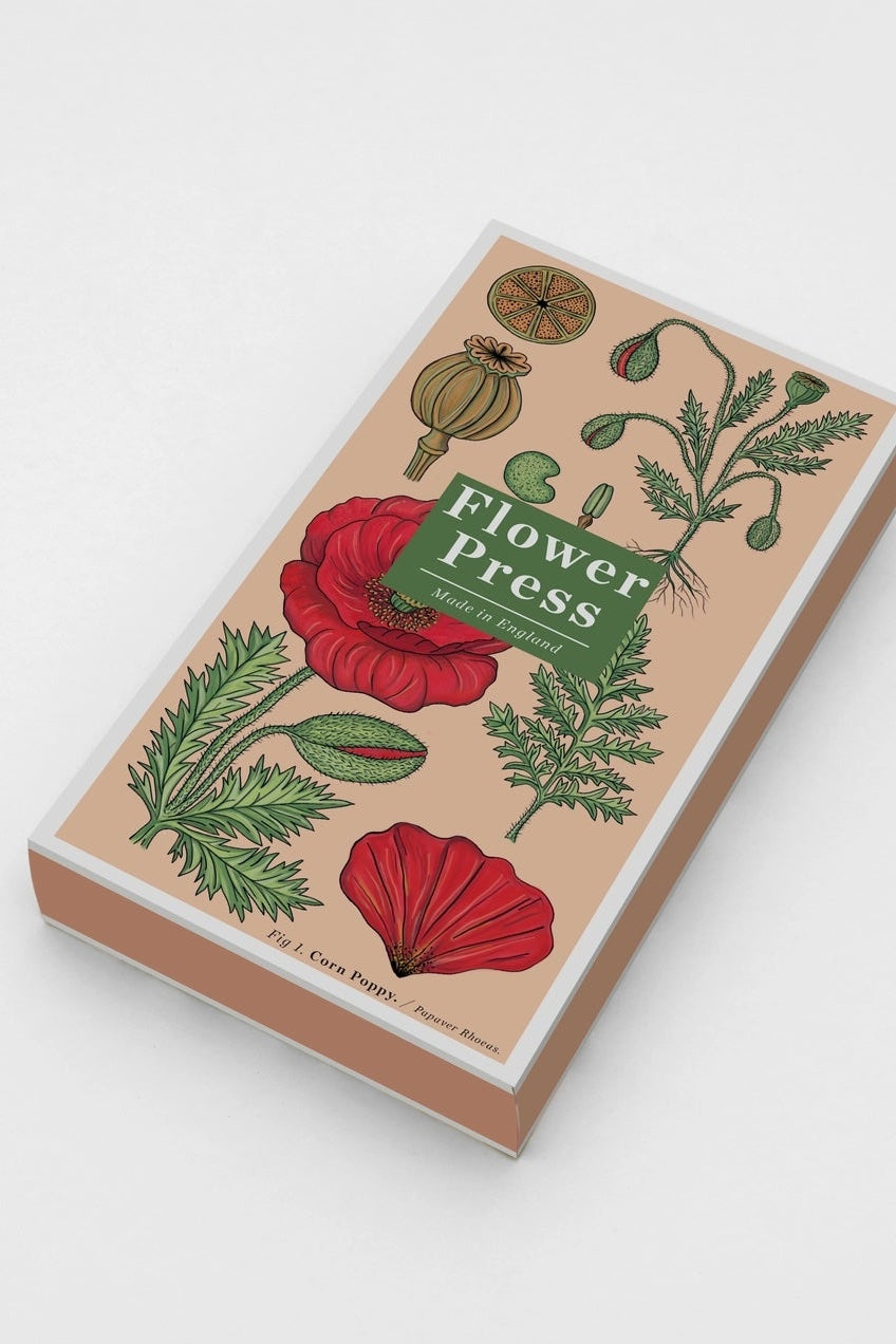 A boxed labeled "flower press" with a red poppy graphic ©Studio Wald