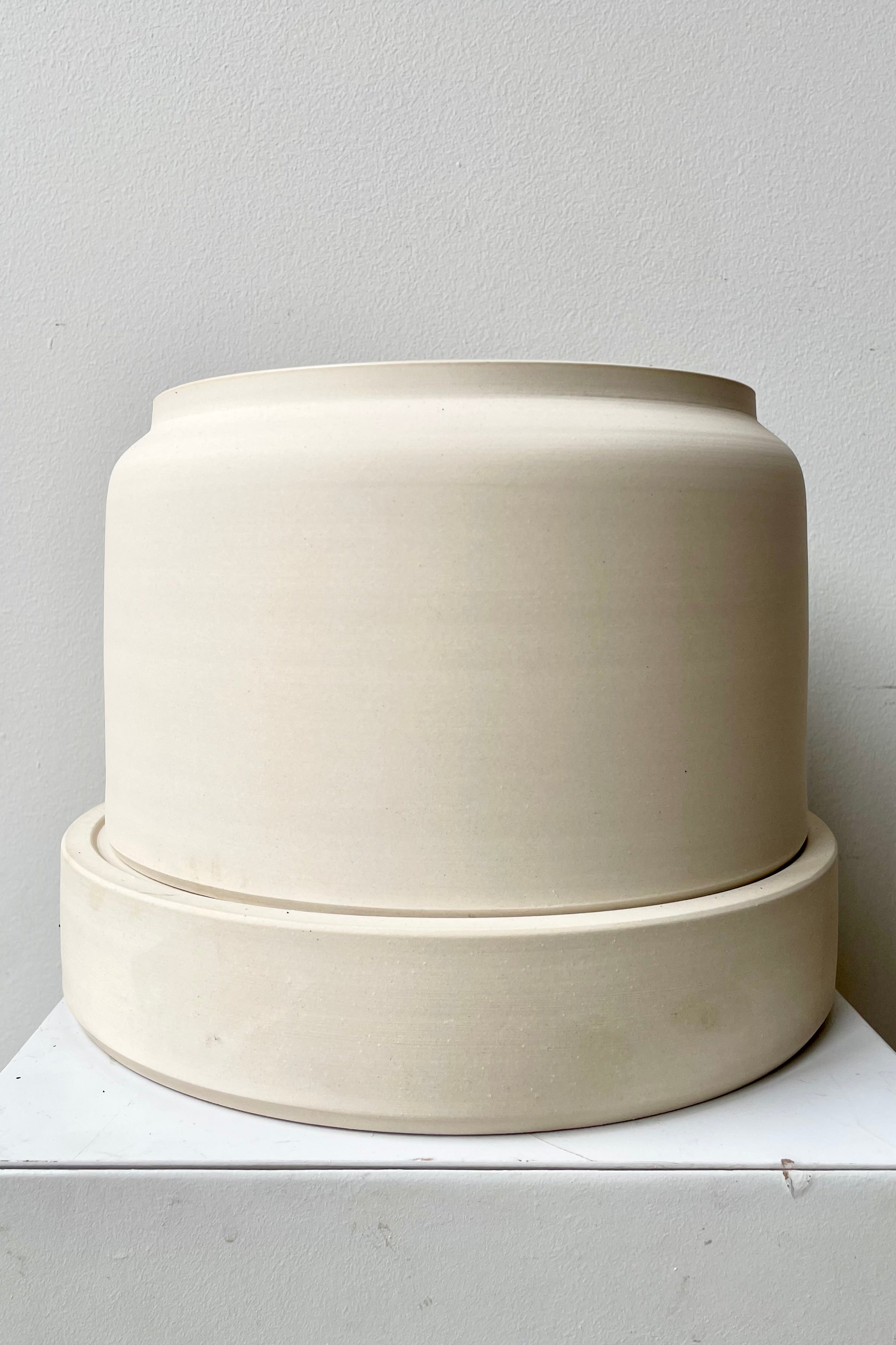 The white wide self watering planter at Sprout Home.