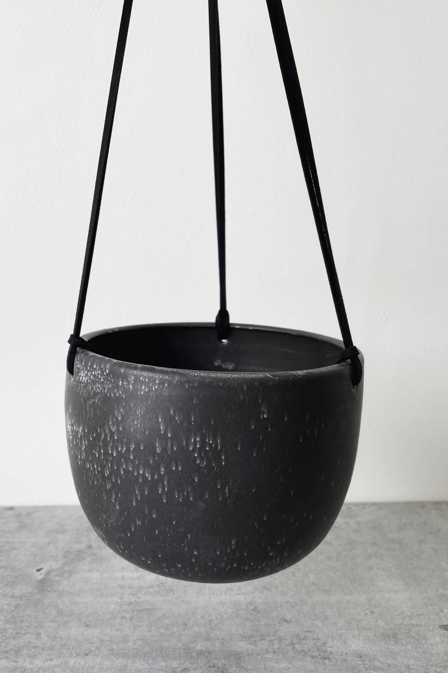 Black hanging planter on a white background ©Little Fire Ceramics
