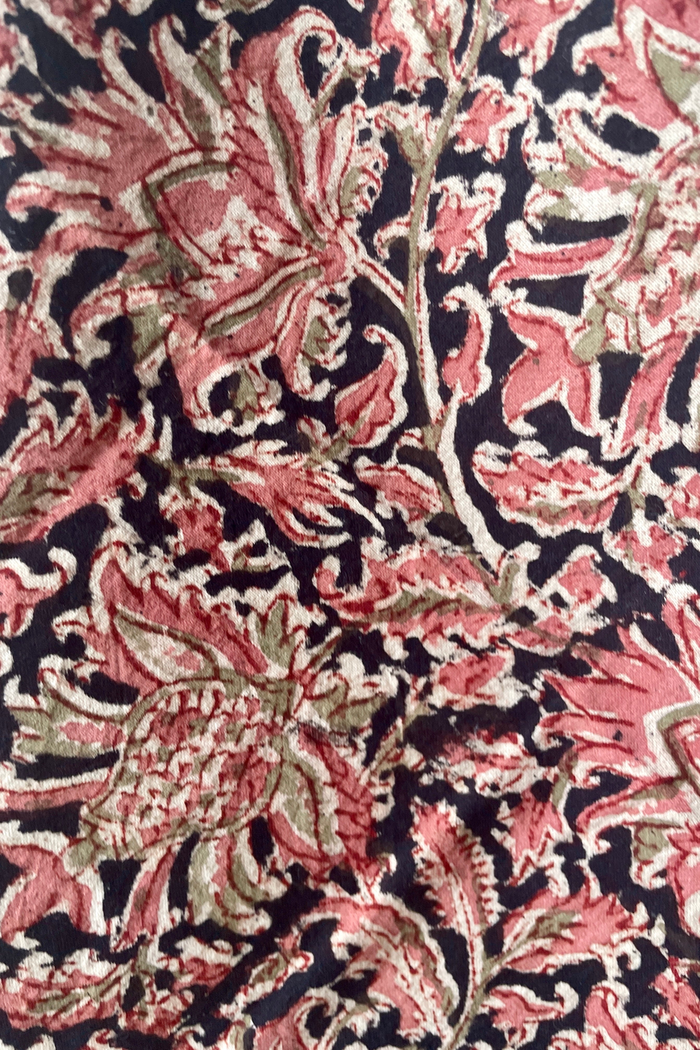 The beautiful rose pink and black print of the Adah napkin in Kesar.