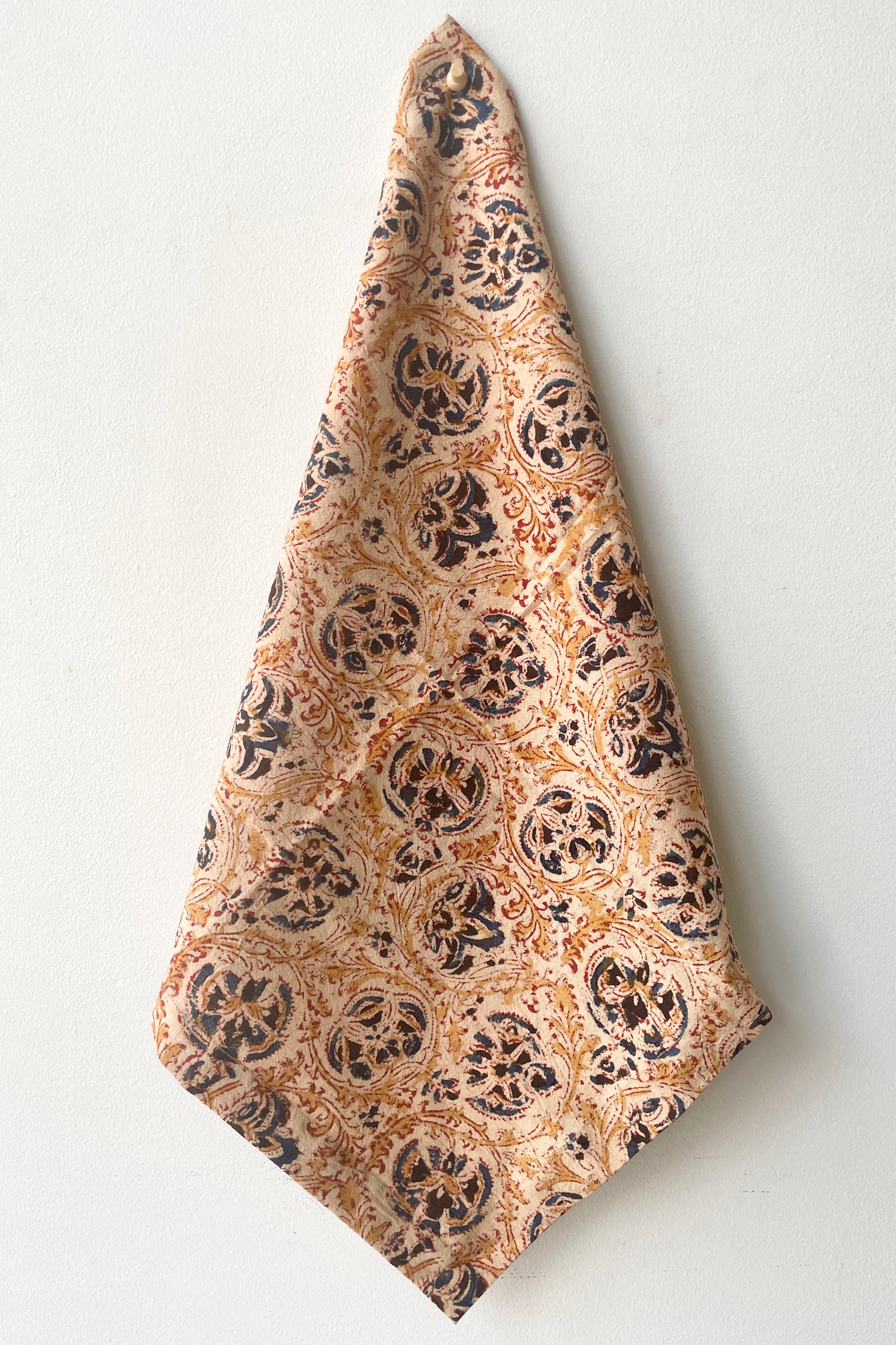 The Adah napkin milli hung against a white wall.