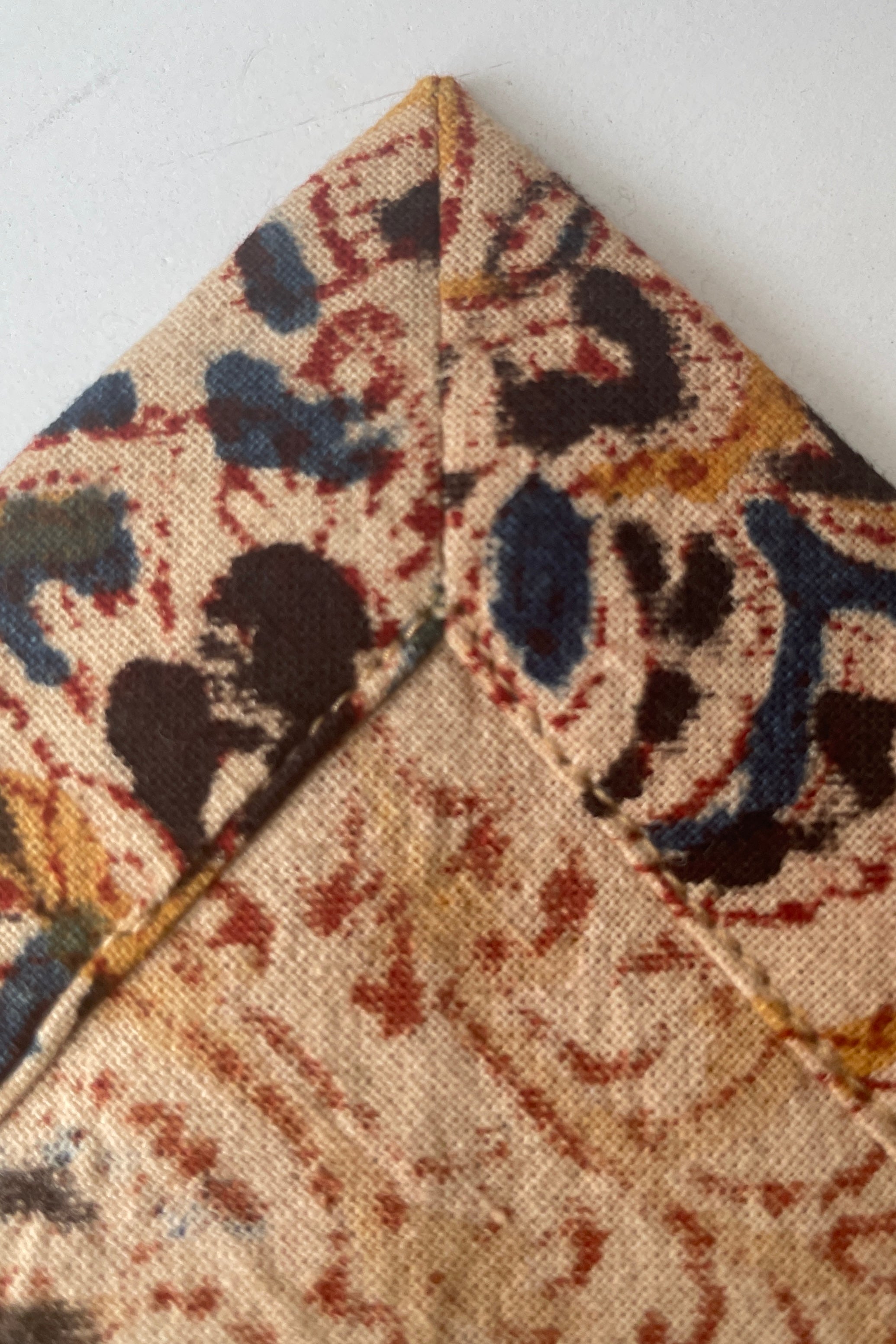 The detail interior corner stitching of the Adah napkins milli.