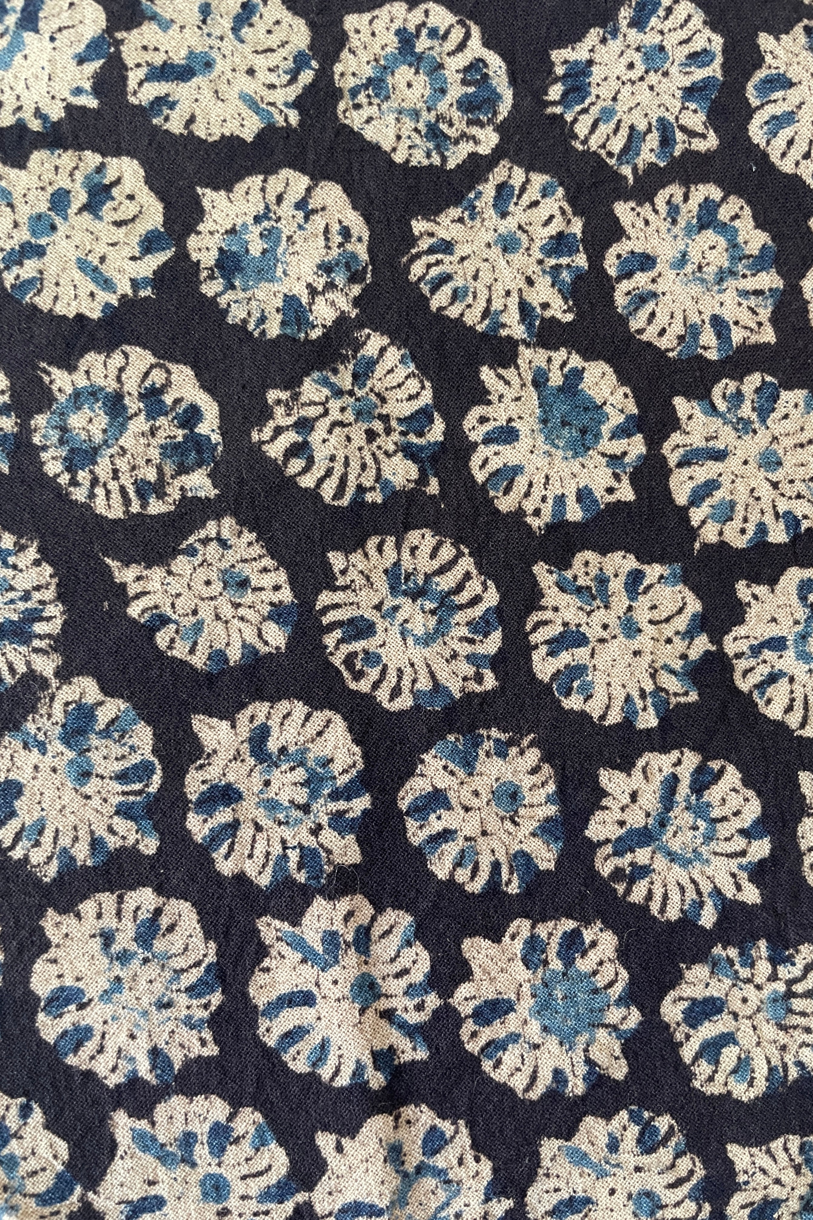 A detail picture of the blue and off-white floral pattern on the Anika Capri napkin