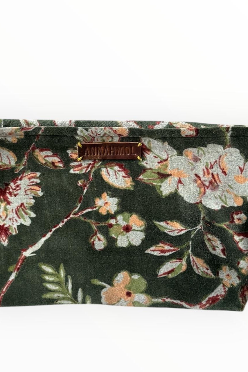 Floral green patterned pouch with a brand label on a white background ©Annahmol