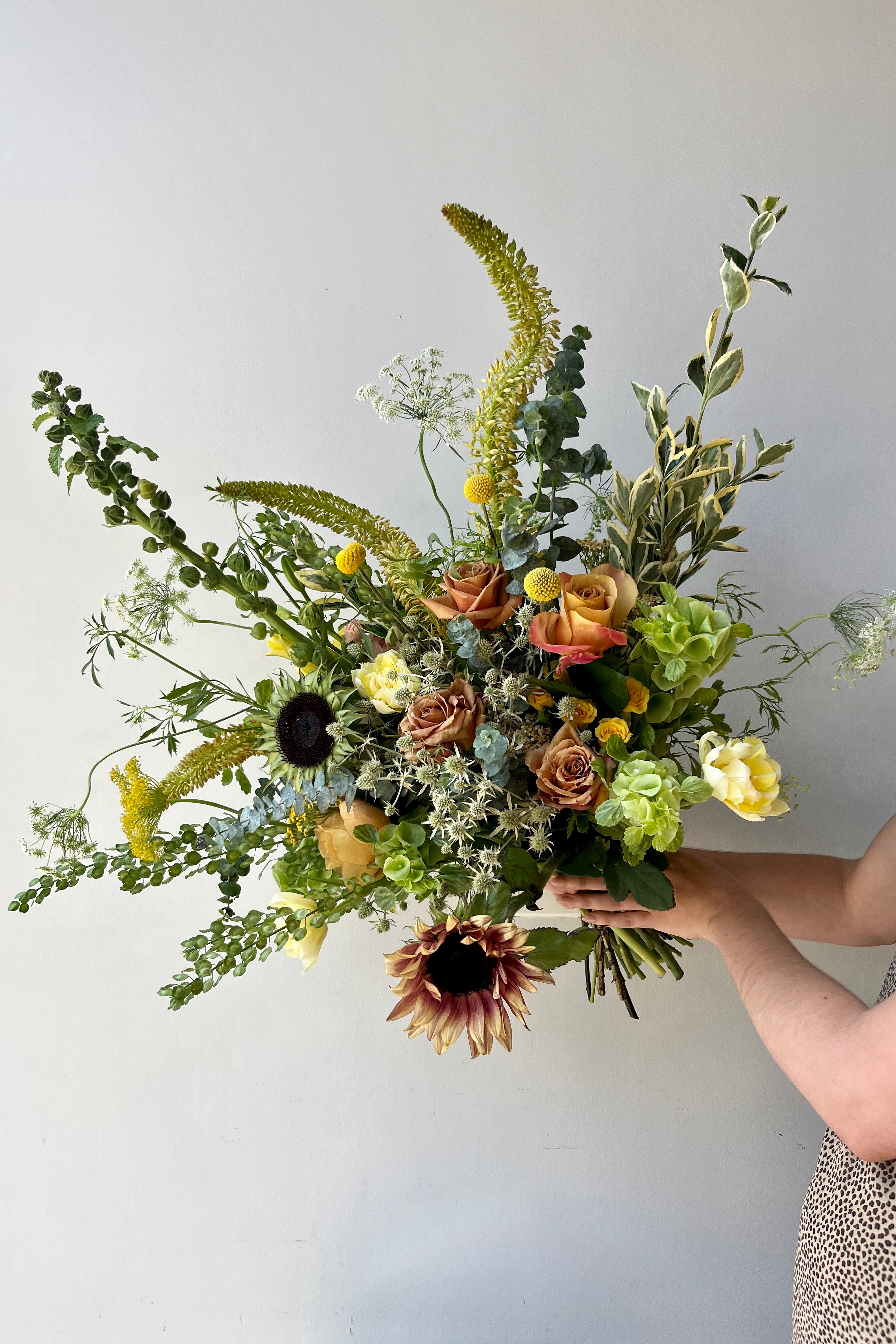 Custom August Champagne Toast arrangement by Sprout Home featuring sunflowers and eremerus. #size_$160