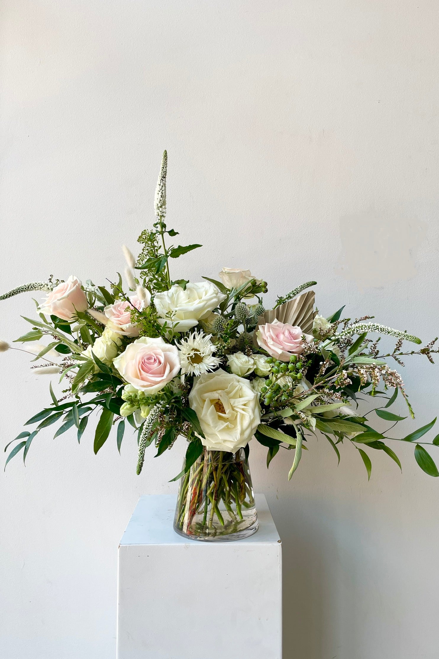 A custom Bleached arrangement with a hint of light pink by Sprout Home. #size_$160