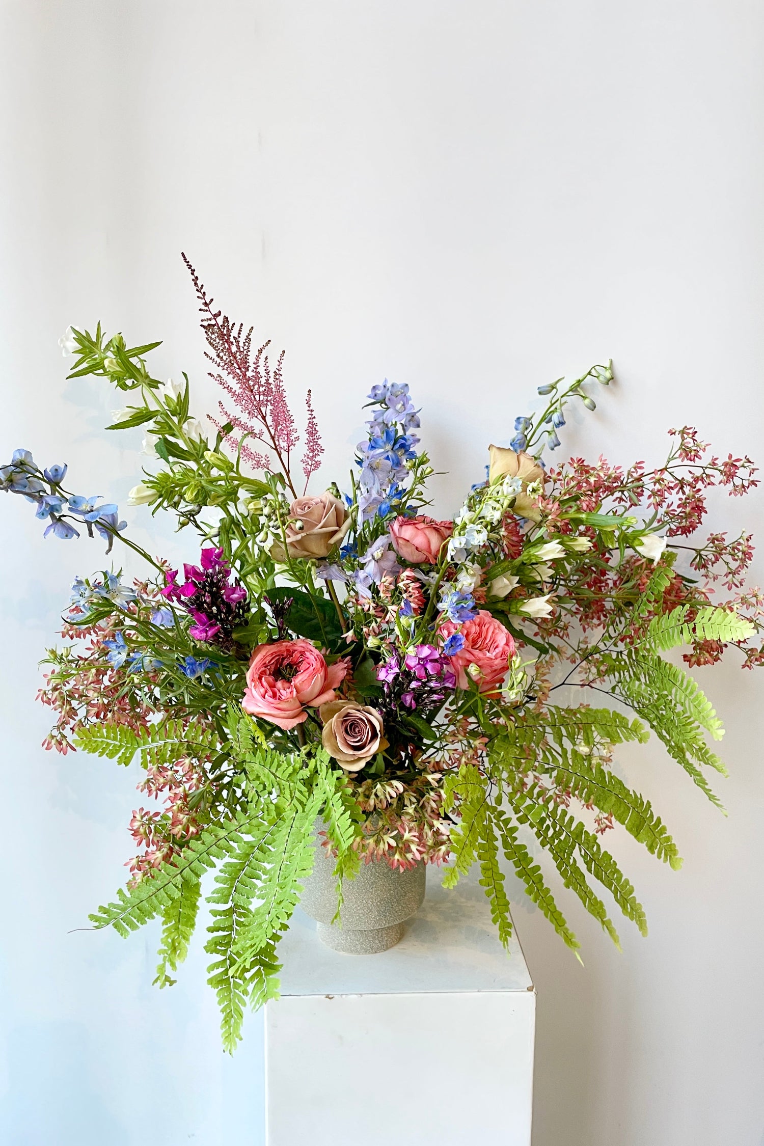 Floral arrangement by SPROUT HOME featuring delicate fern and pastel floral. Photo by Sprout Home.