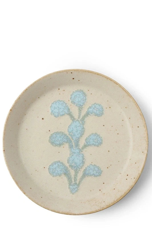 Ivory blue crest plate shown from the topside against a white wall. ©Sprout Home