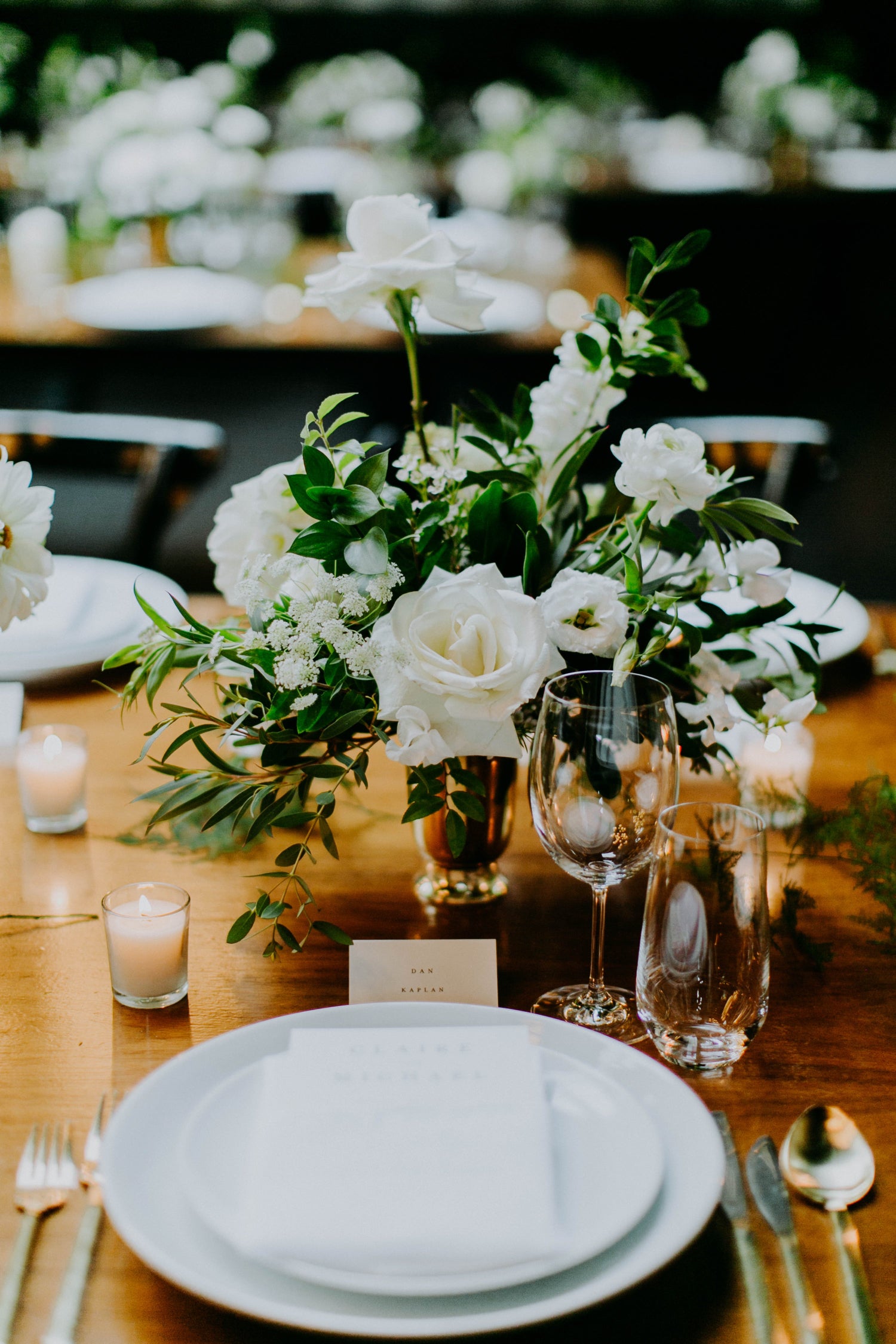 Claire & Mikes wedding at 501 Union in Brooklyn, white floral with dark green foliage in gold vessel on top of wooden table centerpieces. Classy and rich. floral by Sprout Home. Photograph by Amber Gress