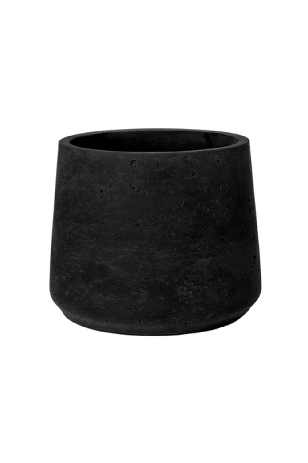 Black Washed Patt pot against a white wall by Pottery Pots