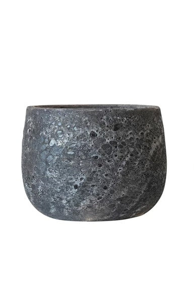 A black round pot with a corse glaze in front of a white background ©Creative Co-Op