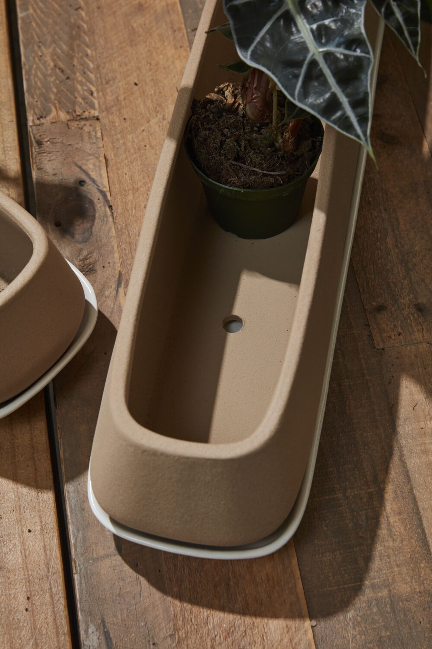 The inside of a Dublin planter shown from above with the drain holes and sitting on a wood table.