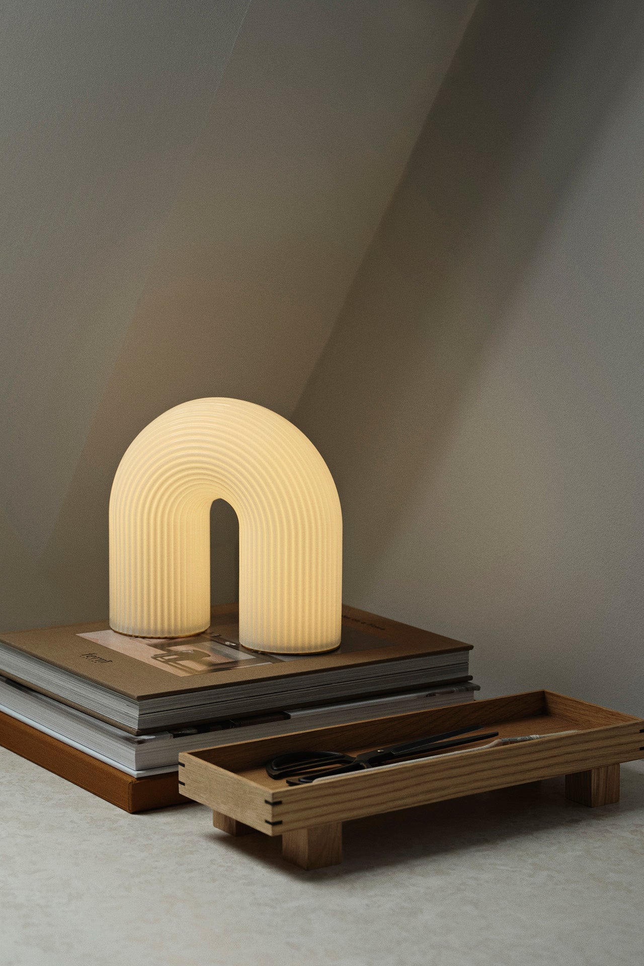 Bon Wooden Tray Oak XS in a styled shot with book and a lamp behind it ©Ferm Living
