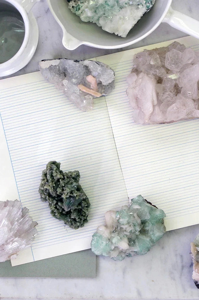 a variety of Zeolite on a lined notebook shown from above.