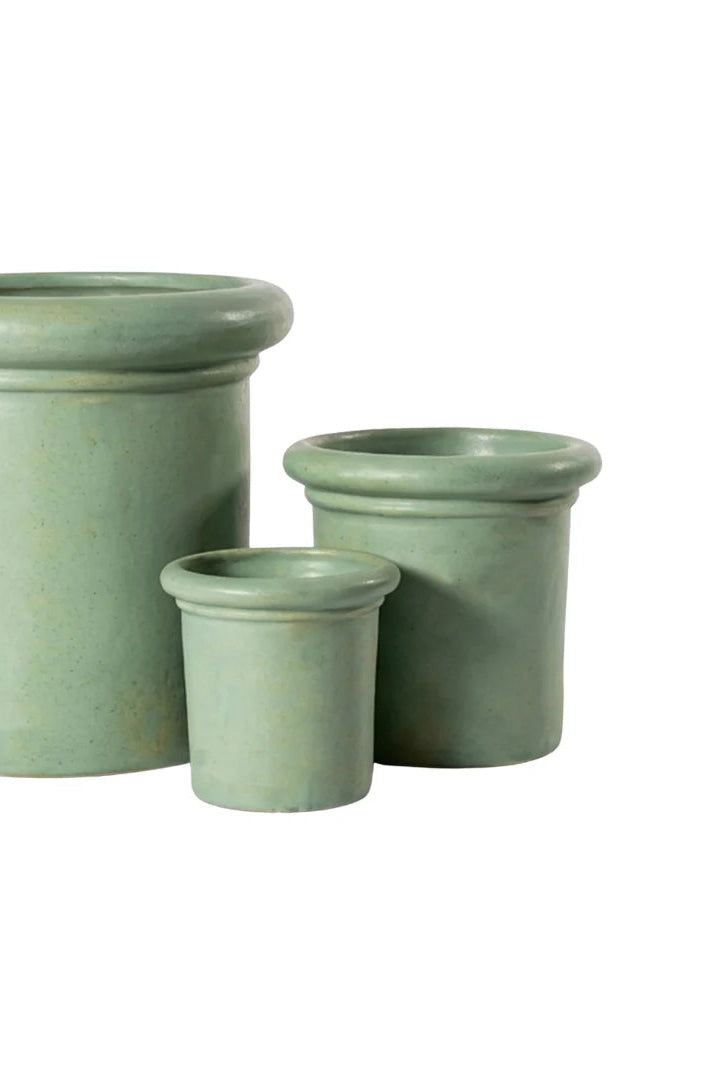 Chubby Rimmed sage colored ceramic planters in a group on white wall ©Anamese