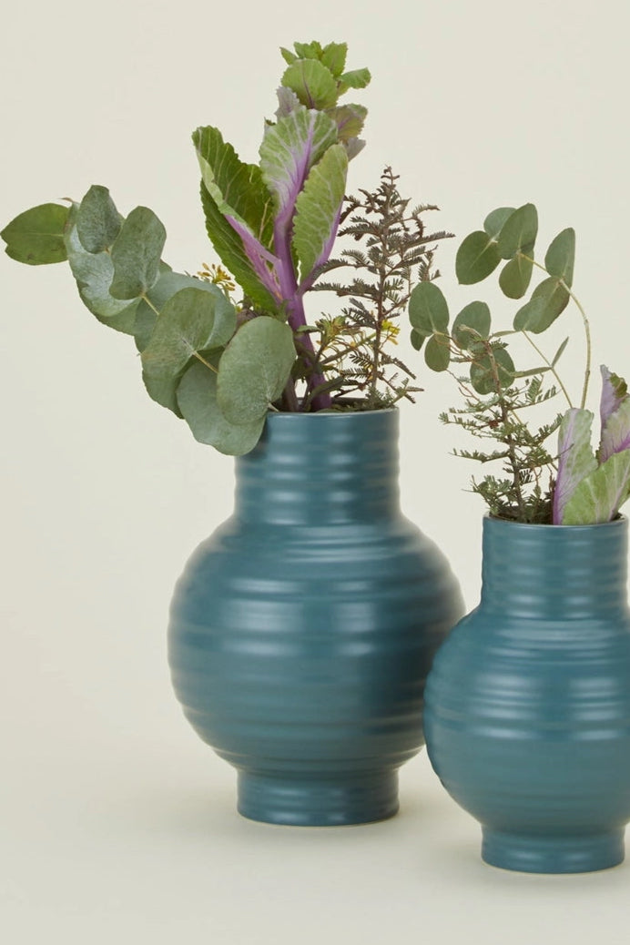 Hawkins New York Essential Peacock Ceramic Vases with ribbed texture and greens inside on a beige background ©Hawkins New York