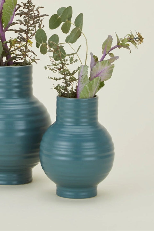 Hawkins New York Essential Peacock Ceramic Vases with ribbed texture and greens inside on a beige background ©Hawkins New York