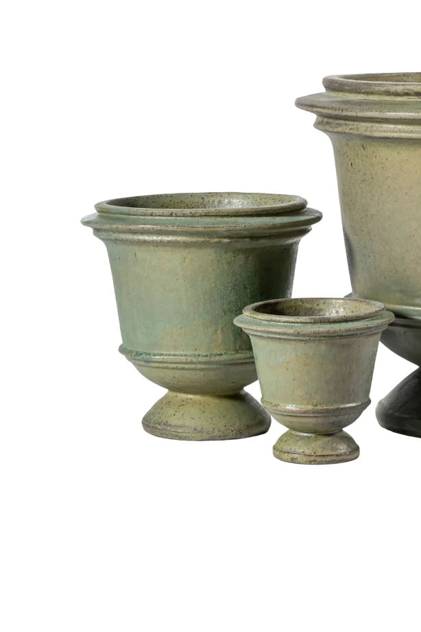 Set of three green ceramic planters of different sizes on a white background ©Anamese
