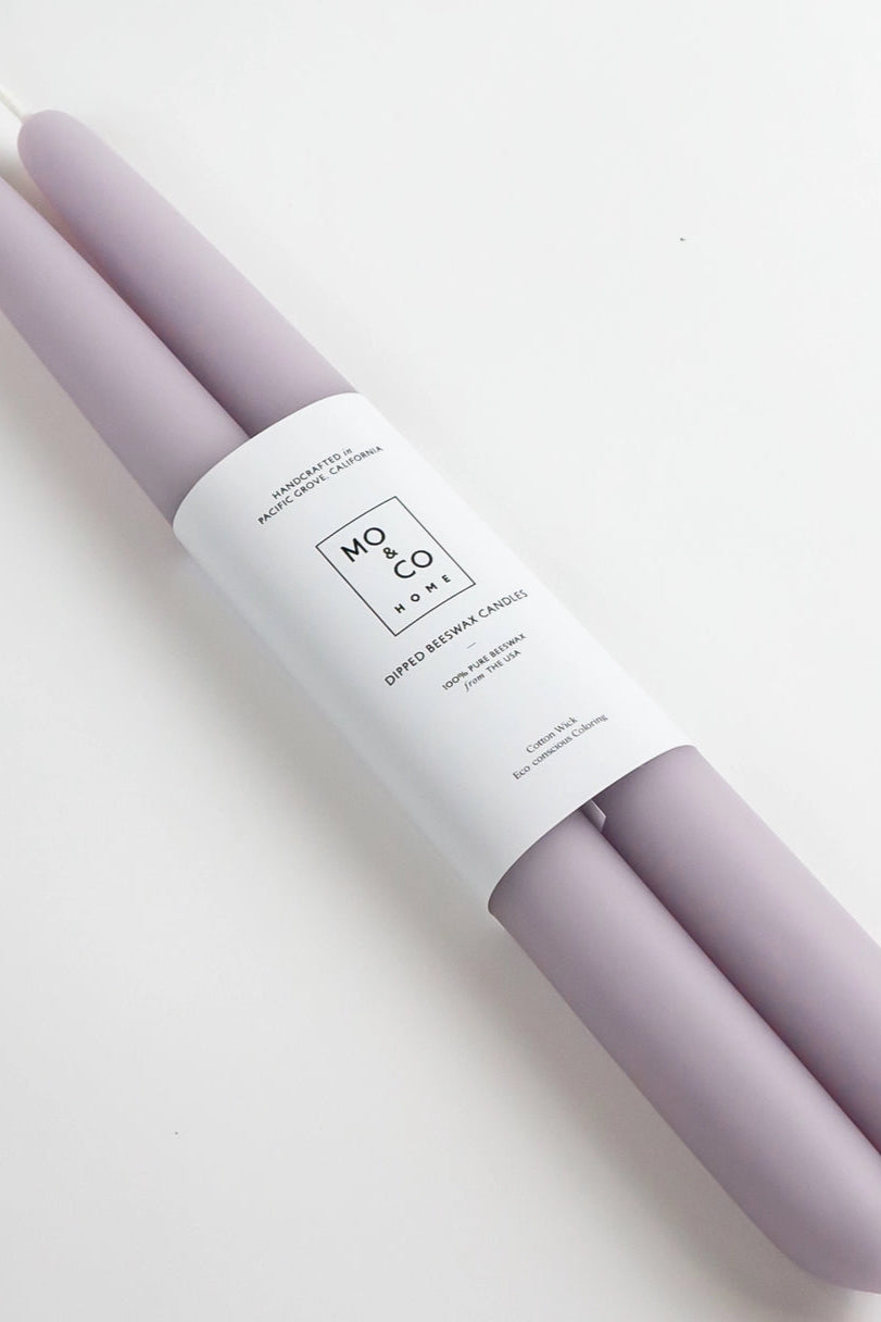 Lavender 14" Beeswax Taper Candles Set sin packaging with branding on a light gray background ©Mo & Co.