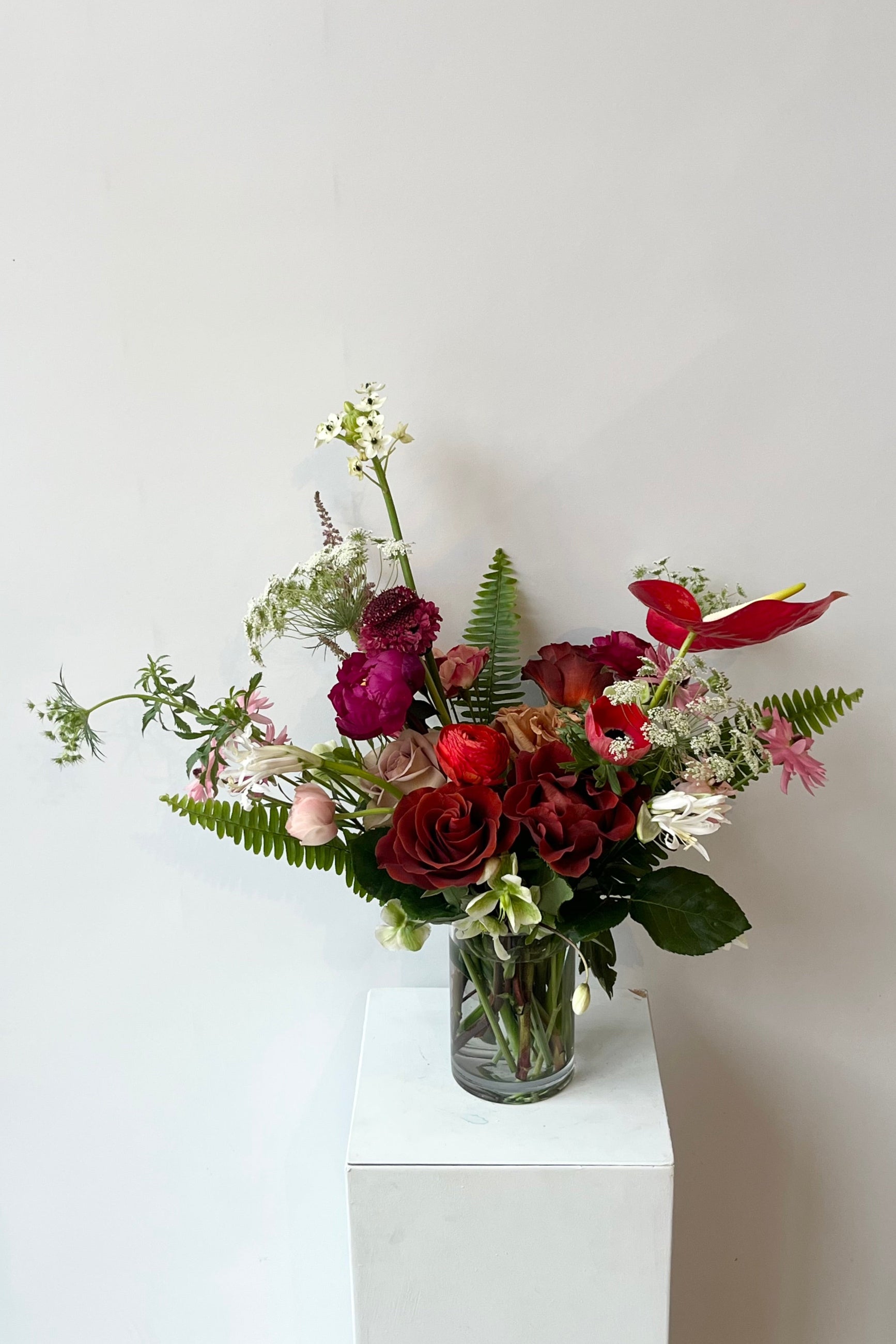 Custom arrangement by Sprout Home in shades of deep and bright reds and burgundies ©Sprout Home #size_$130