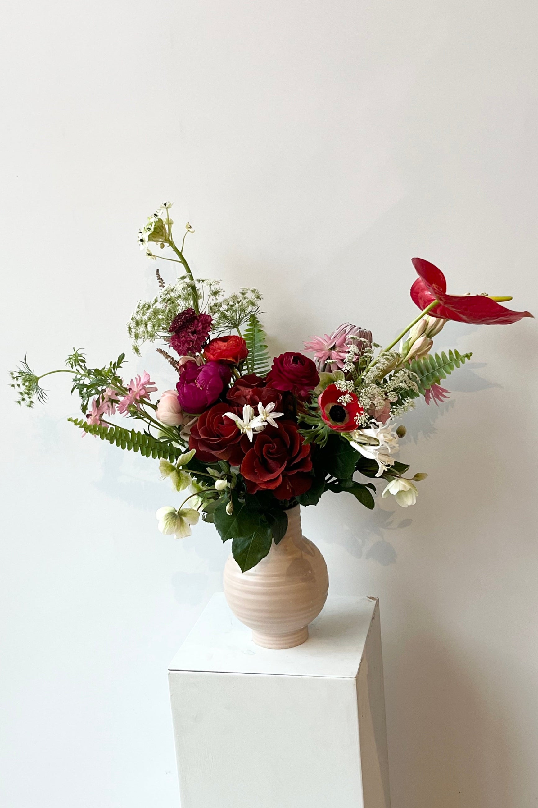 Modern Love arrangement arrangement by Sprout Home in a light pink essential vase with popping anthurium ©Sprout Home #size_$160