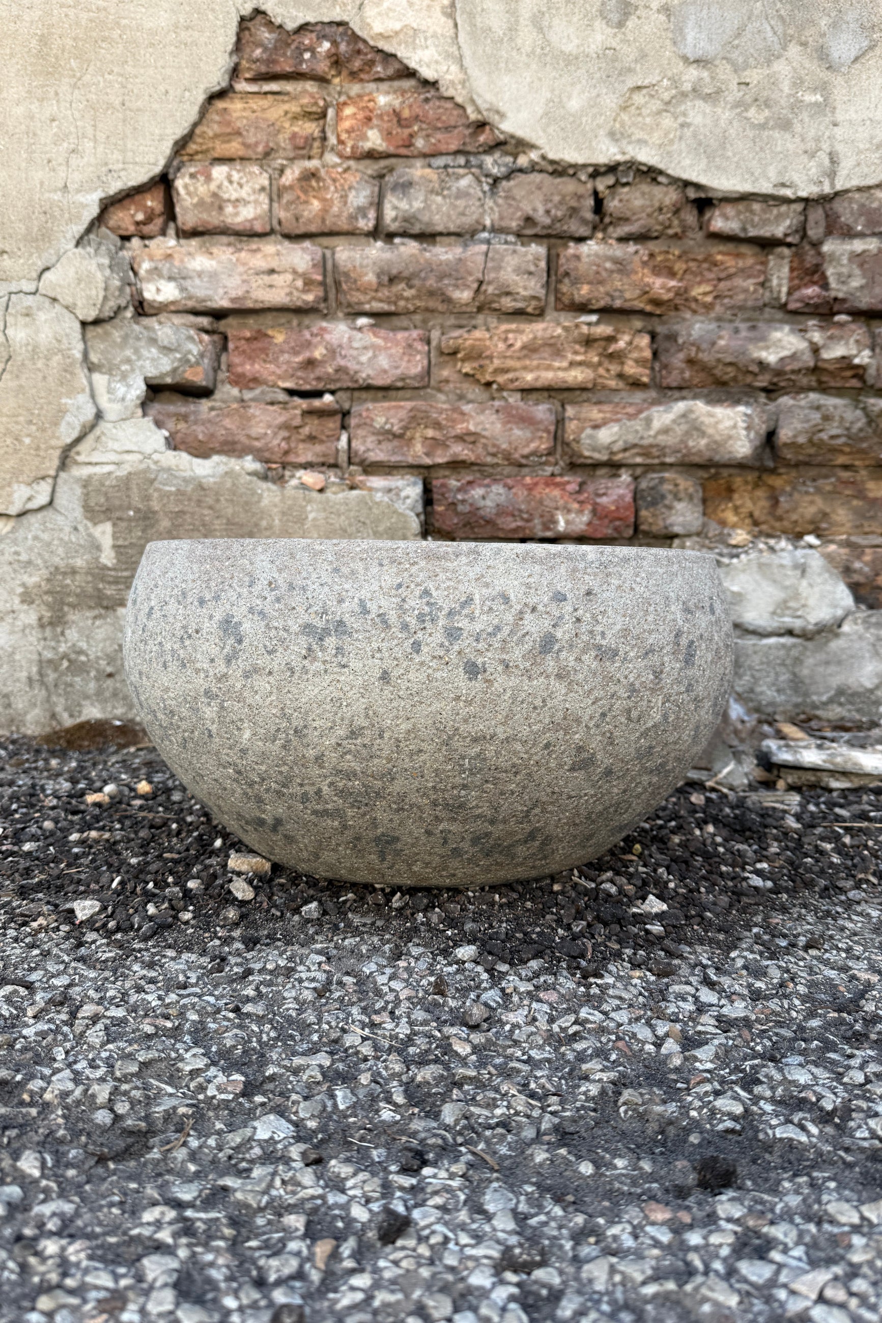 Low Ficonstone Greige Low Bowl Mediumon a stone surface with a brick wall background ©Sprout Home