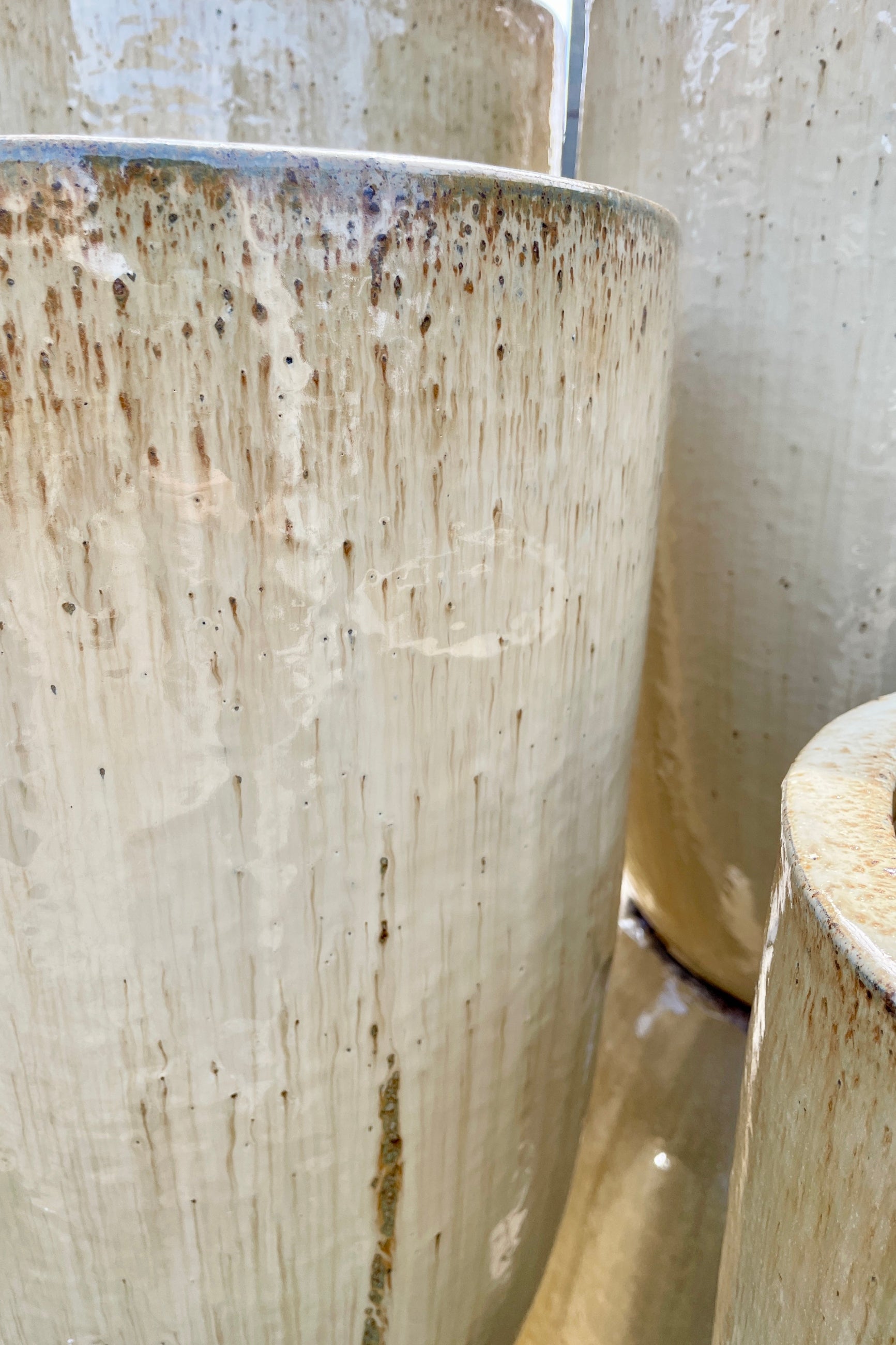 A detail of the finish on the Sand Crucible planter showing the brown drips marks in the glaze. ©Sprout Home