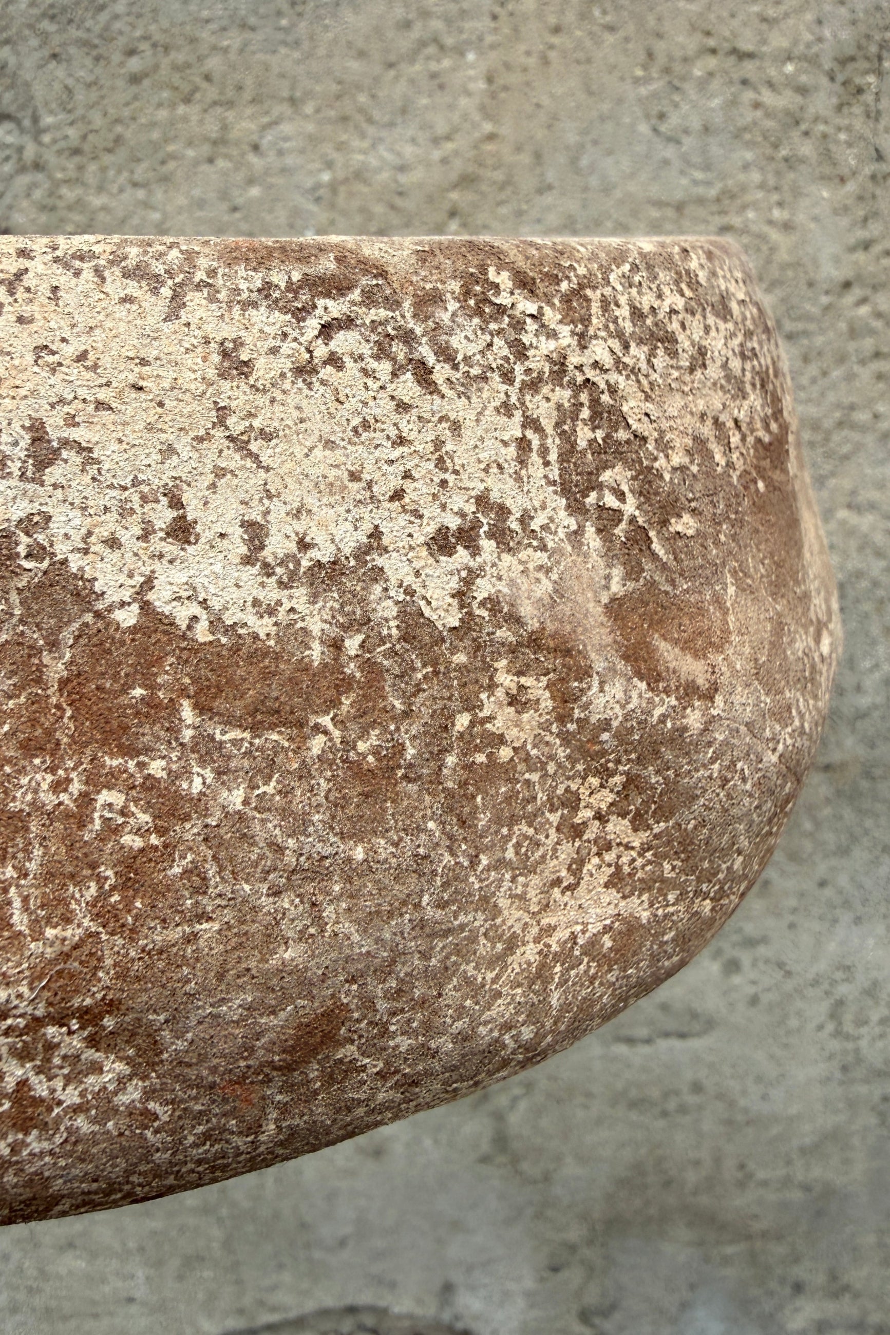 Close-up of a textured Sansui Tapered Vietnamese Rustic Small stone bowl on a concrete surface ©Sprout Home