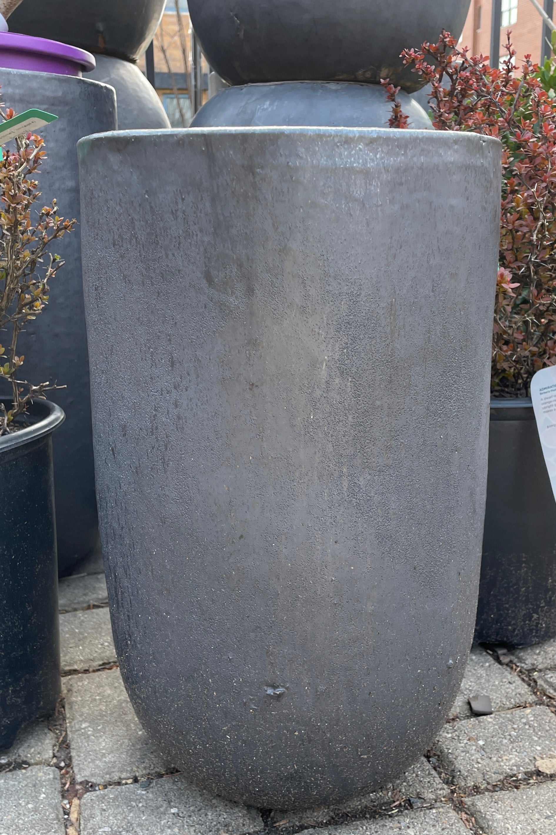 A graphite crucible planter, empty, and viewed from the side.