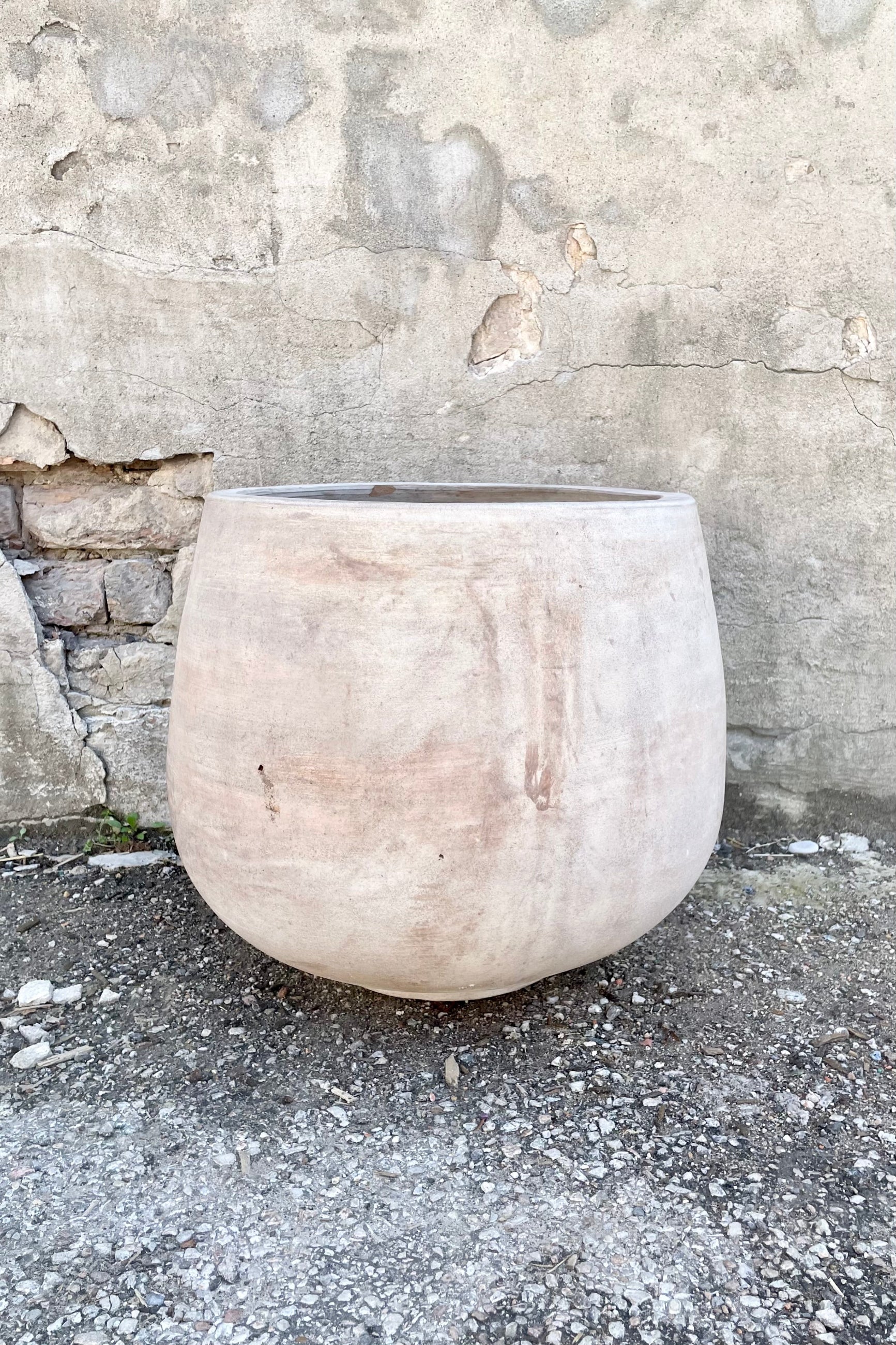 Yumiko Unglazed Planter Large against a grey wall ©Sprout Home